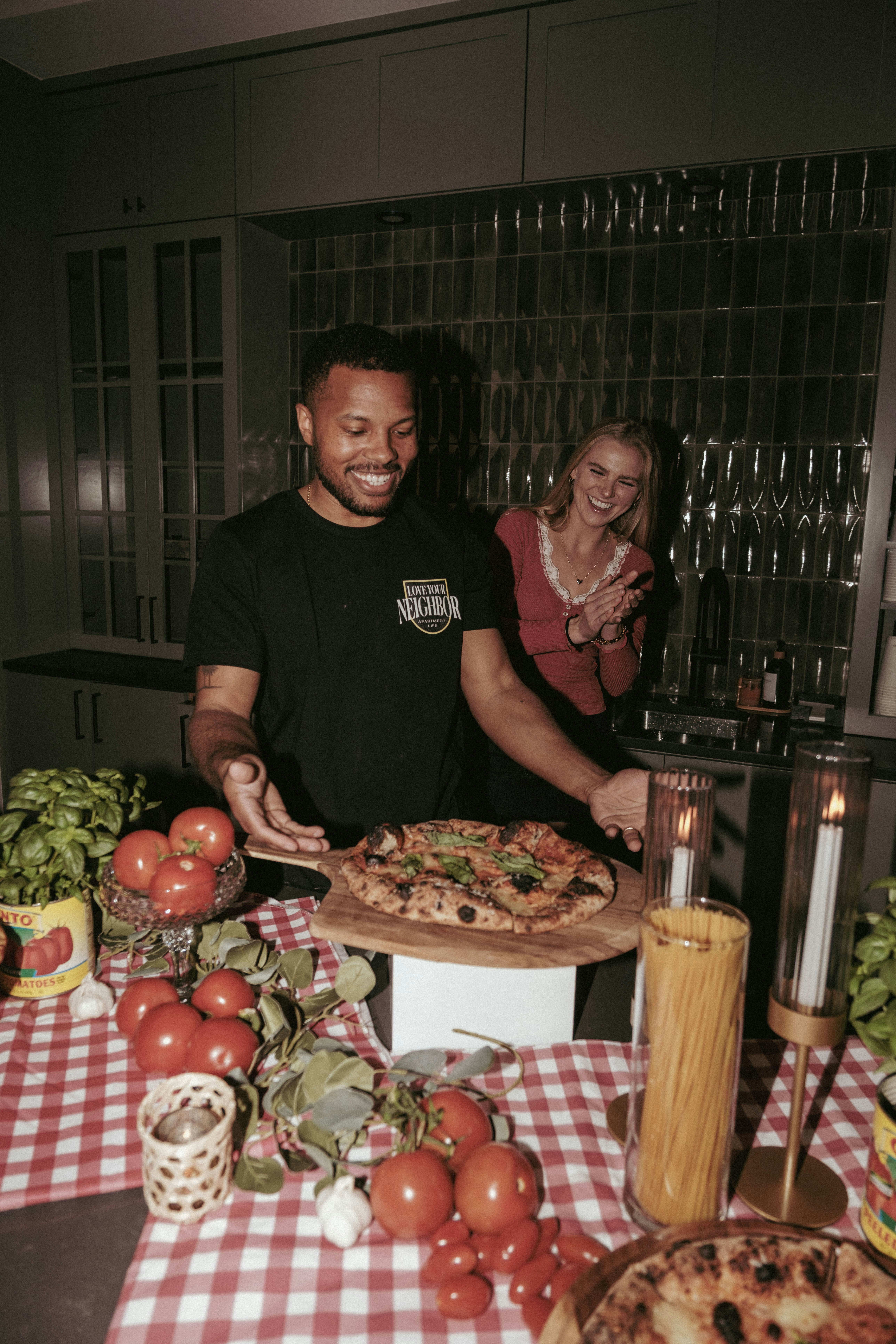 Man proudly presents freshly baked pizza