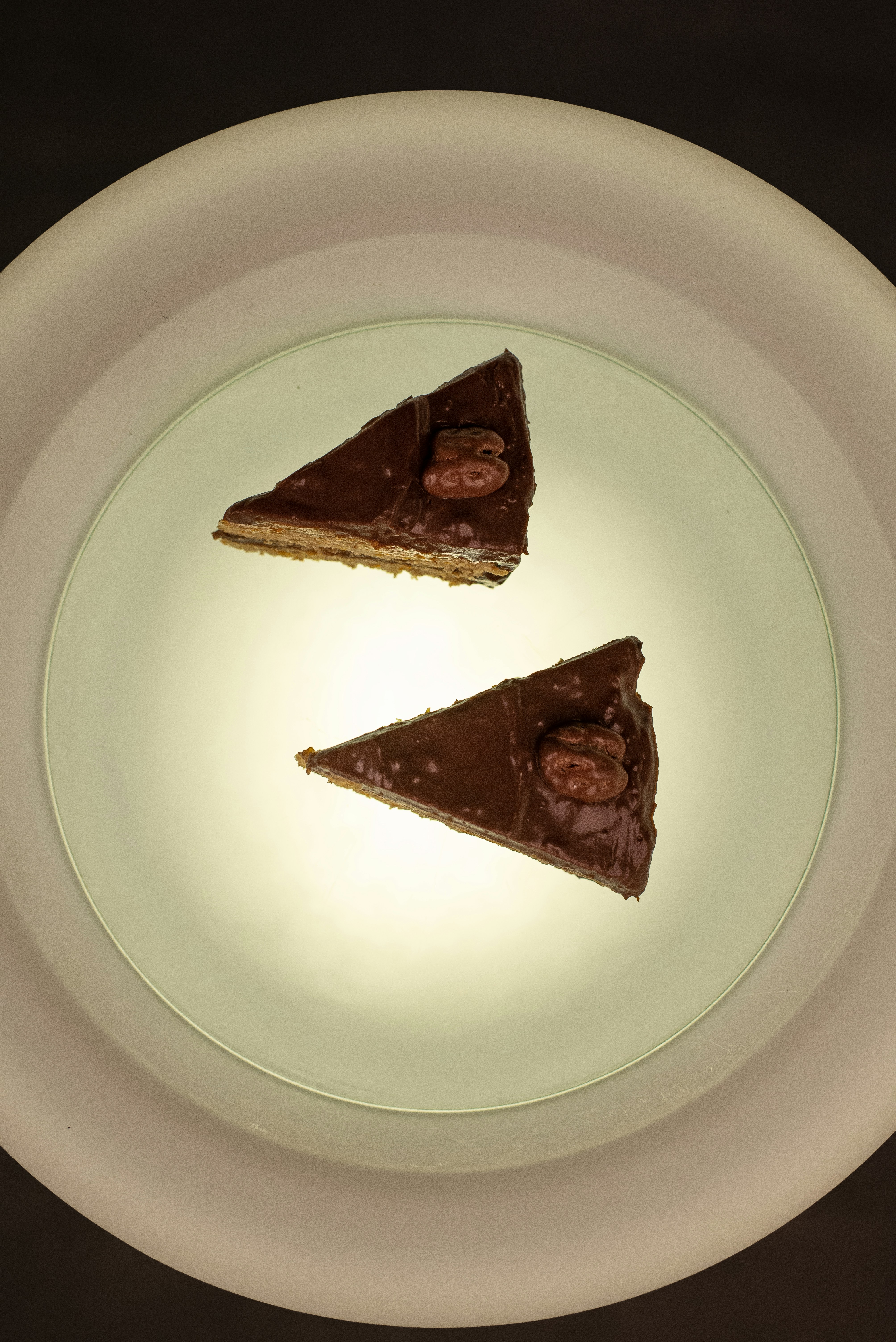 Two slices of chocolate cake with walnuts