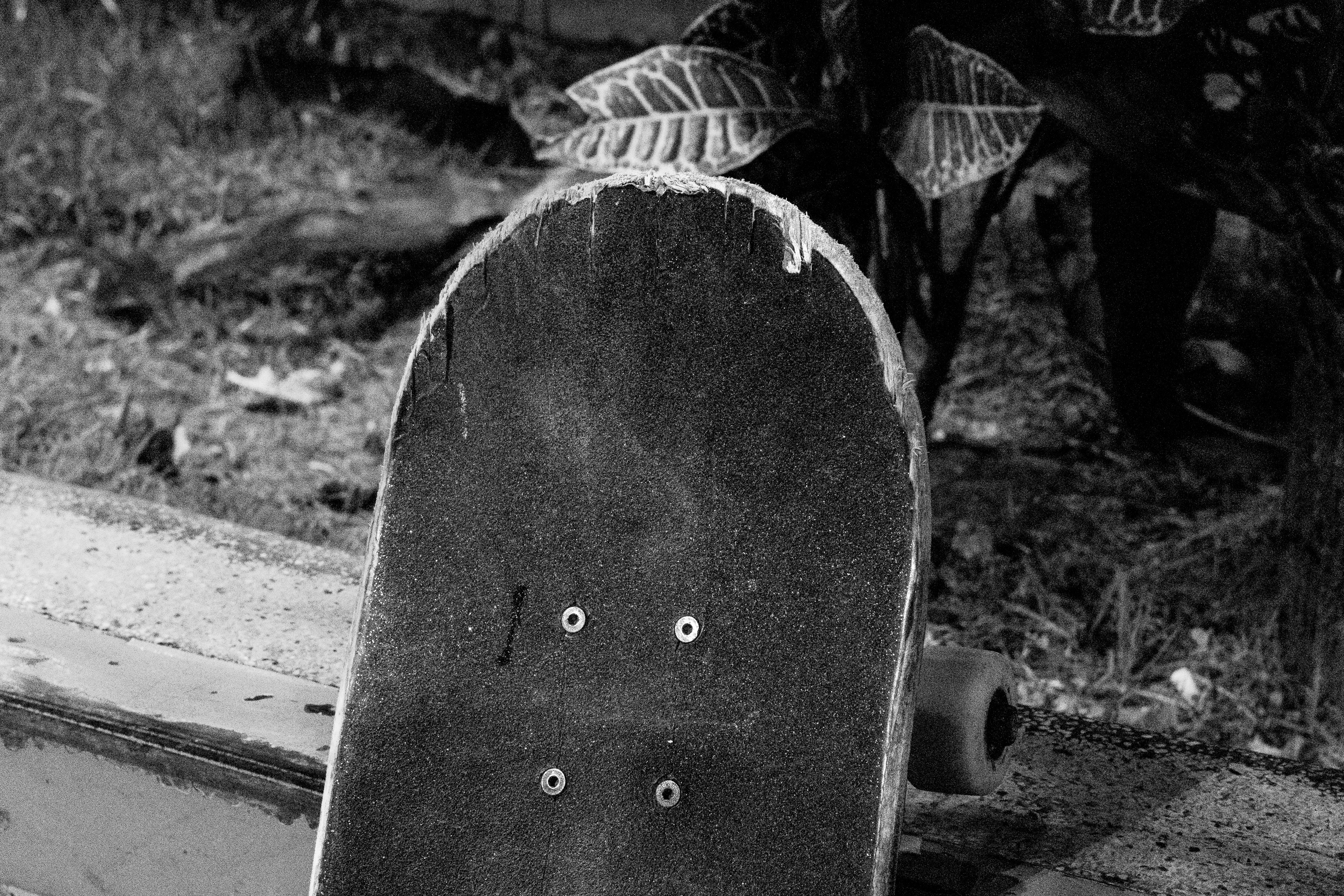 Close-up of a worn skateboard deck with grip tape