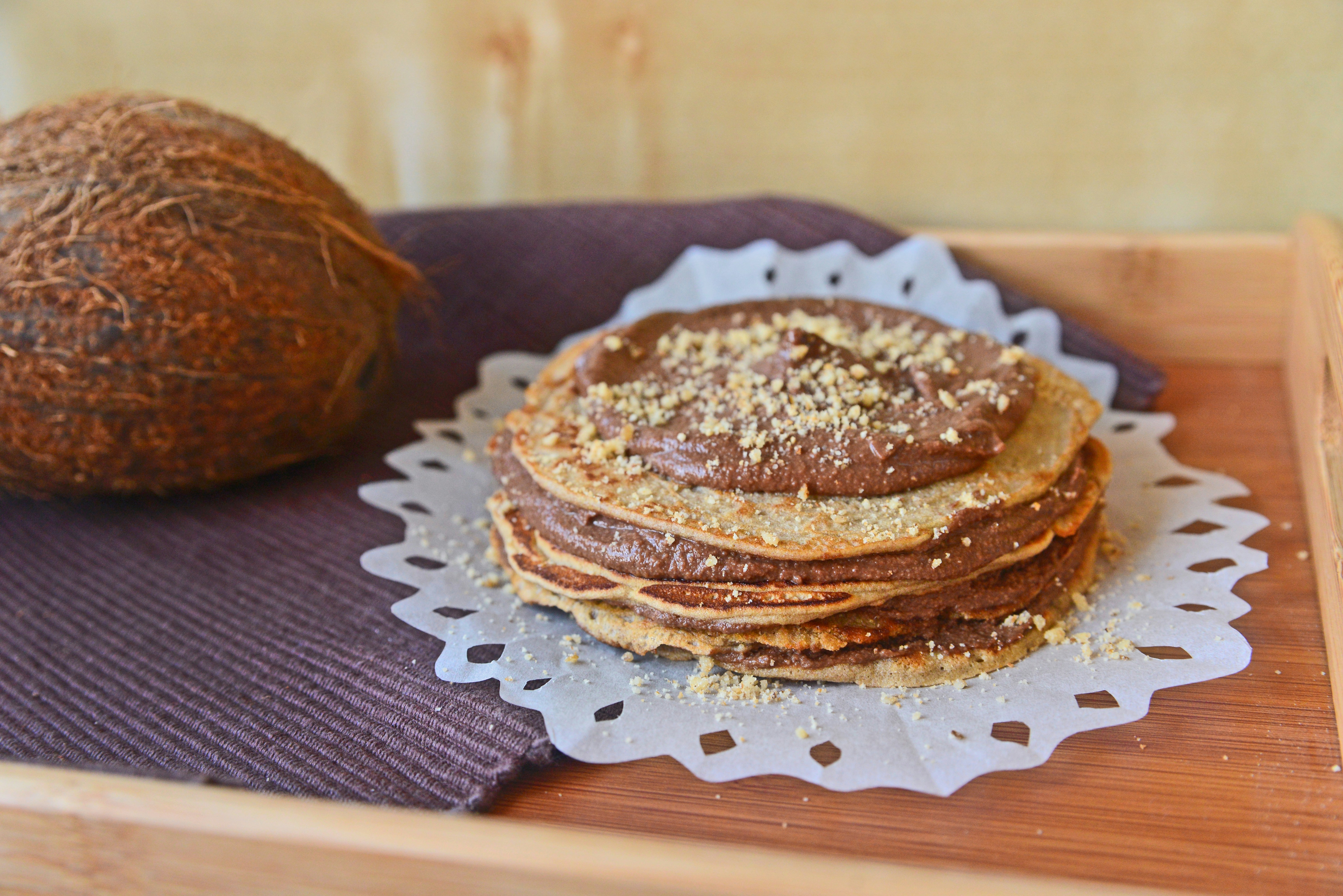 Stack of crepes with chocolate spread and coconut