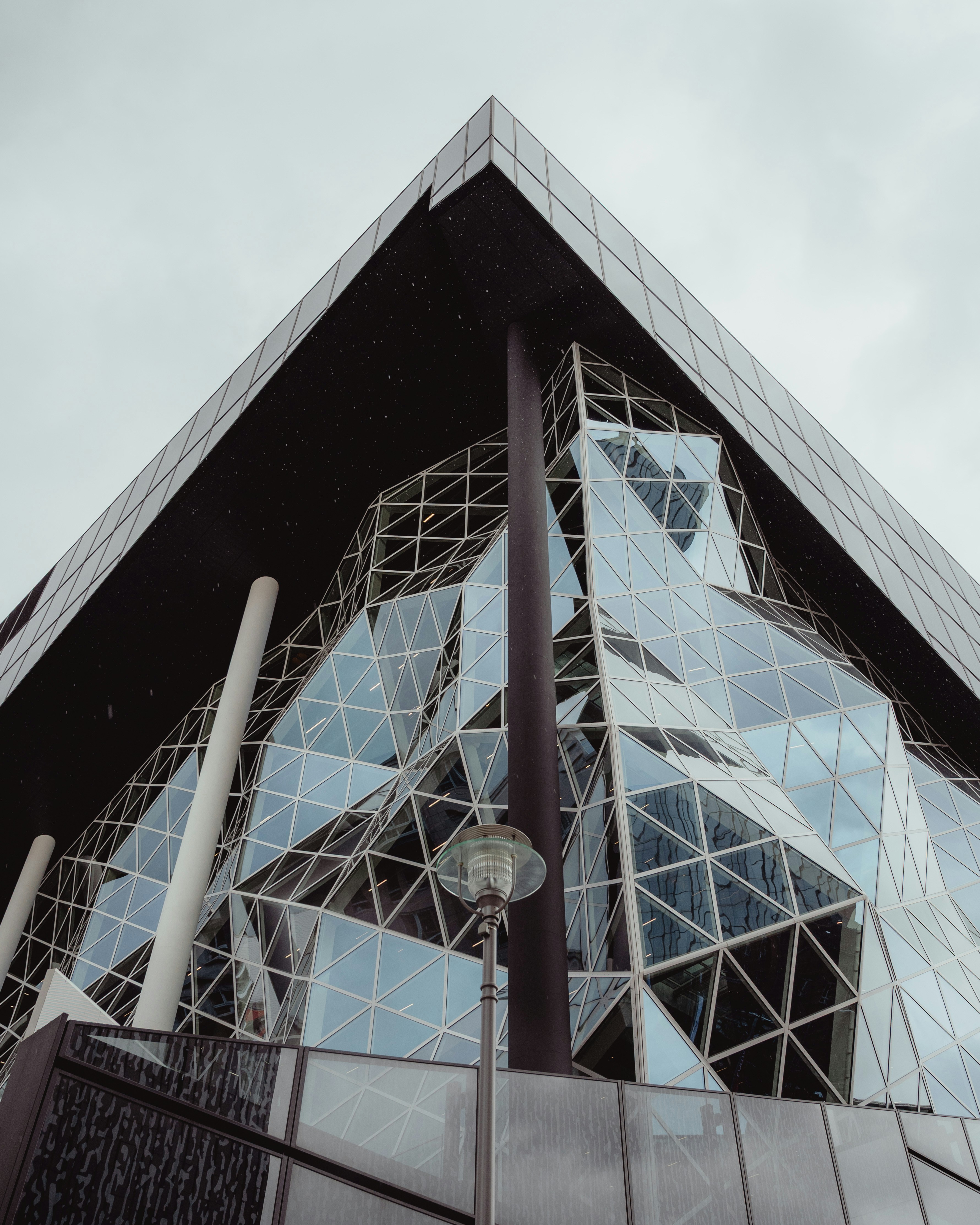 Modern building with geometric glass facade and dark exterior
