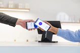 Customer paying with smartphone at point of sale terminal.