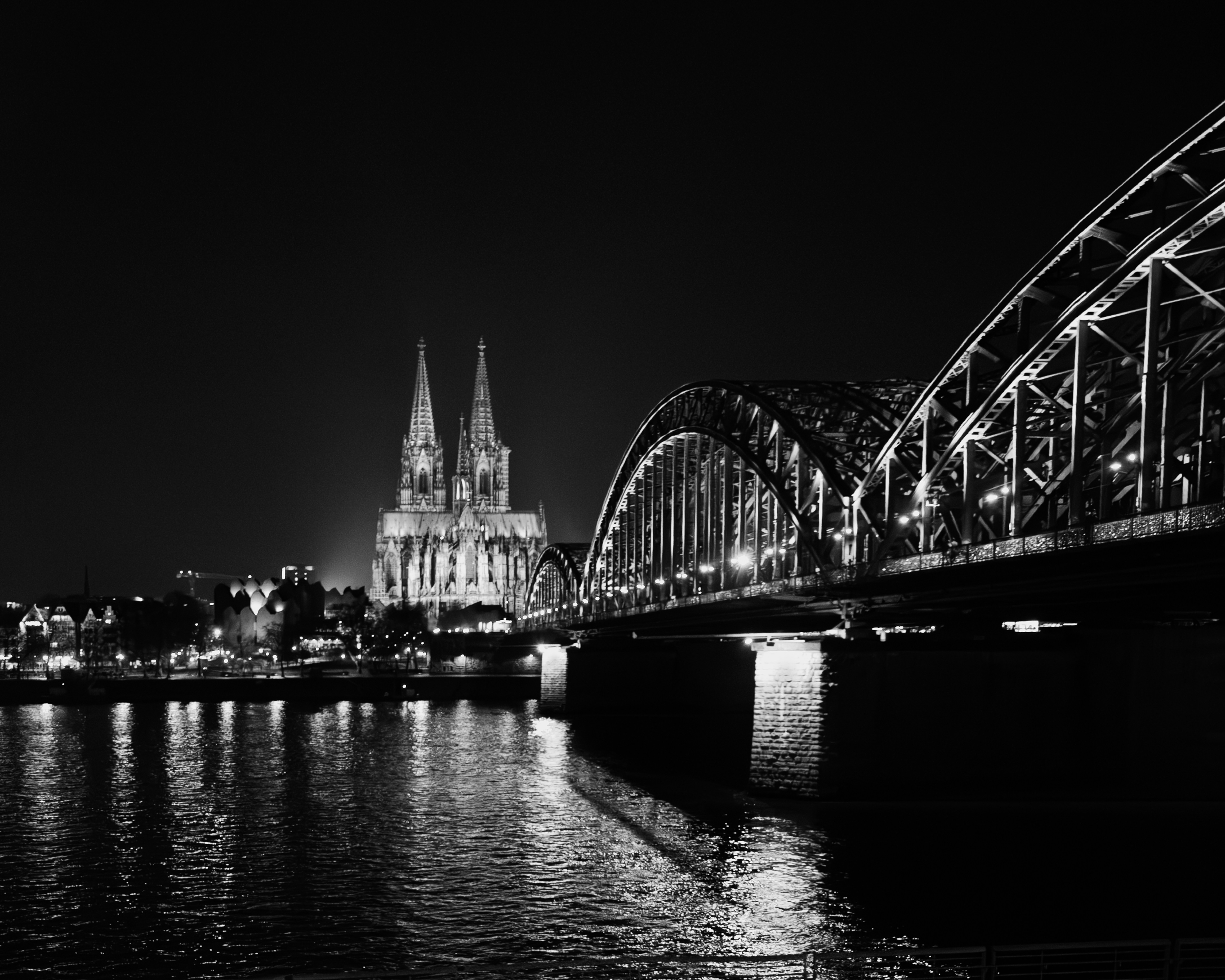 Illuminated bridge and cathedral at night