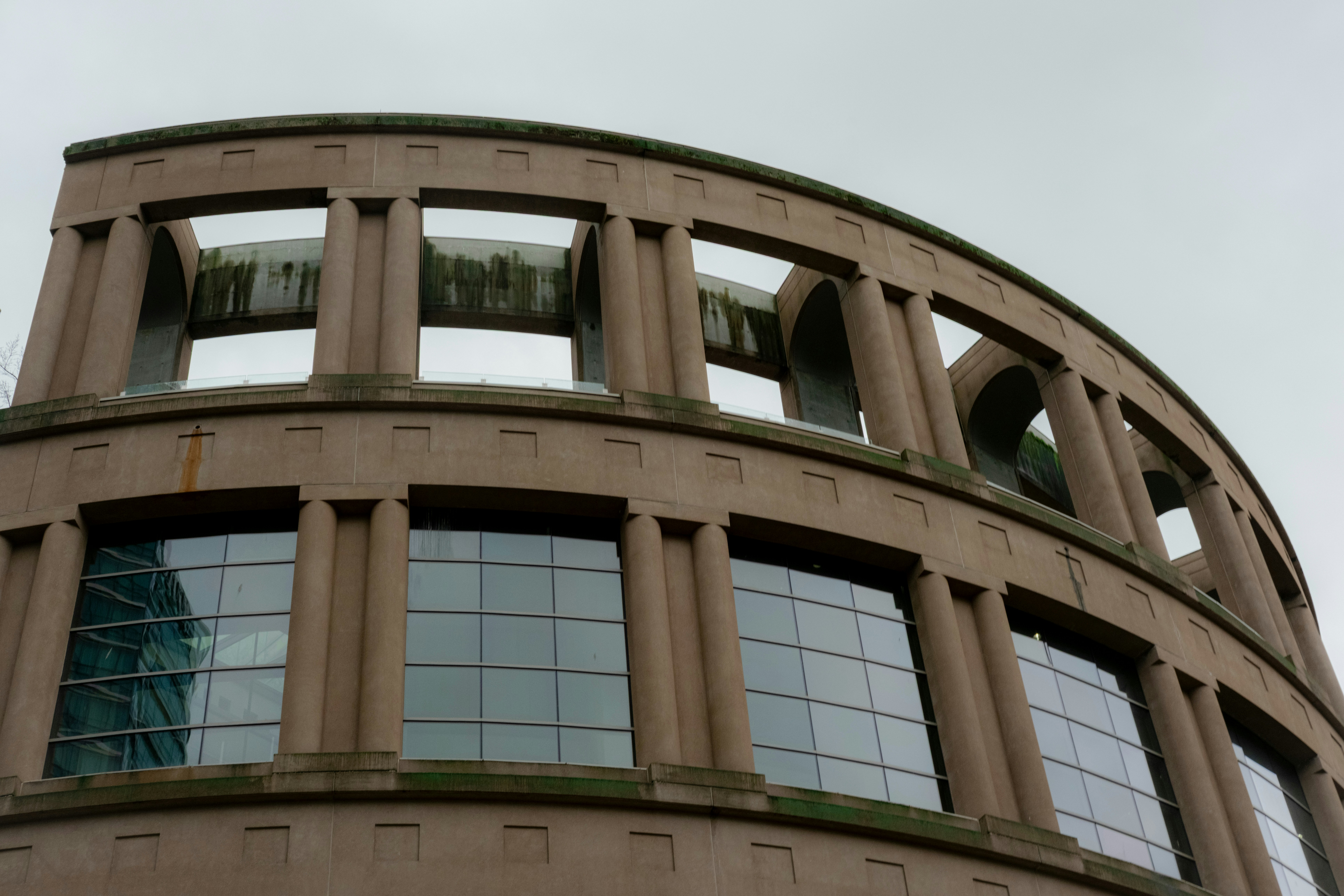 Curved stone building with large windows