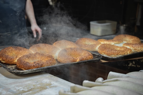 Fresh bread coming out of stone oven at sunrise