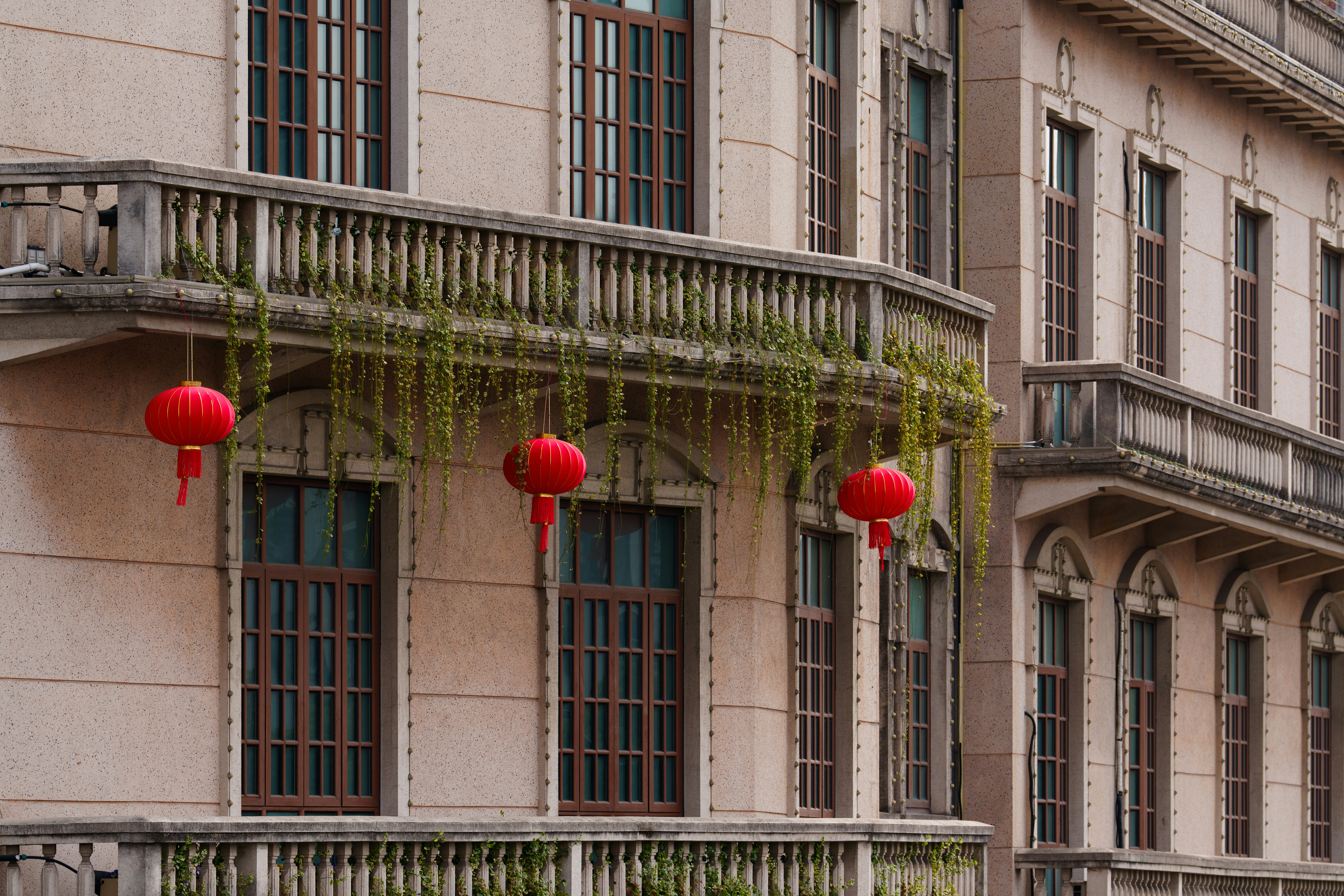 Balcony with red lanterns and hanging plants