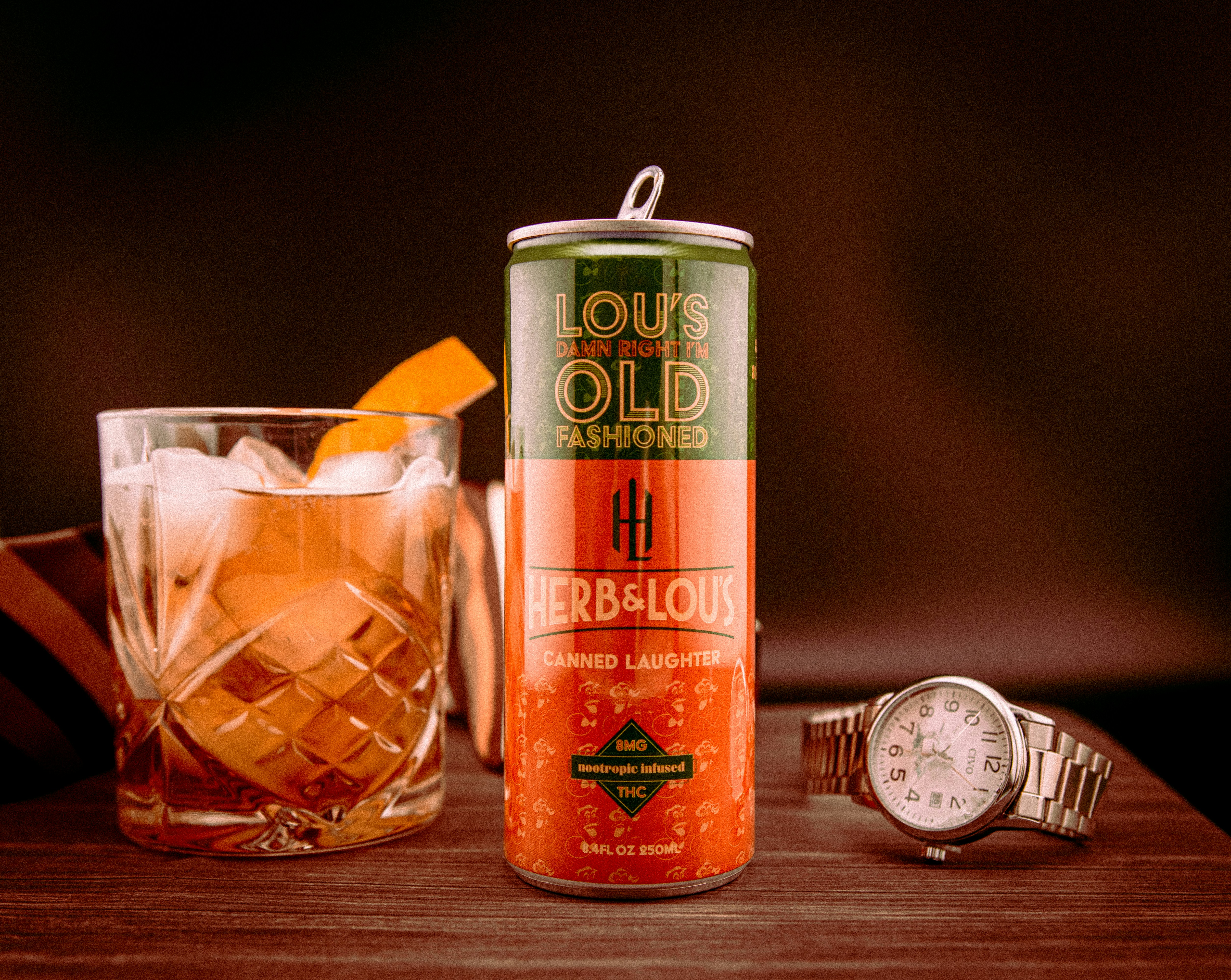 Old fashioned cocktail with can and watch.