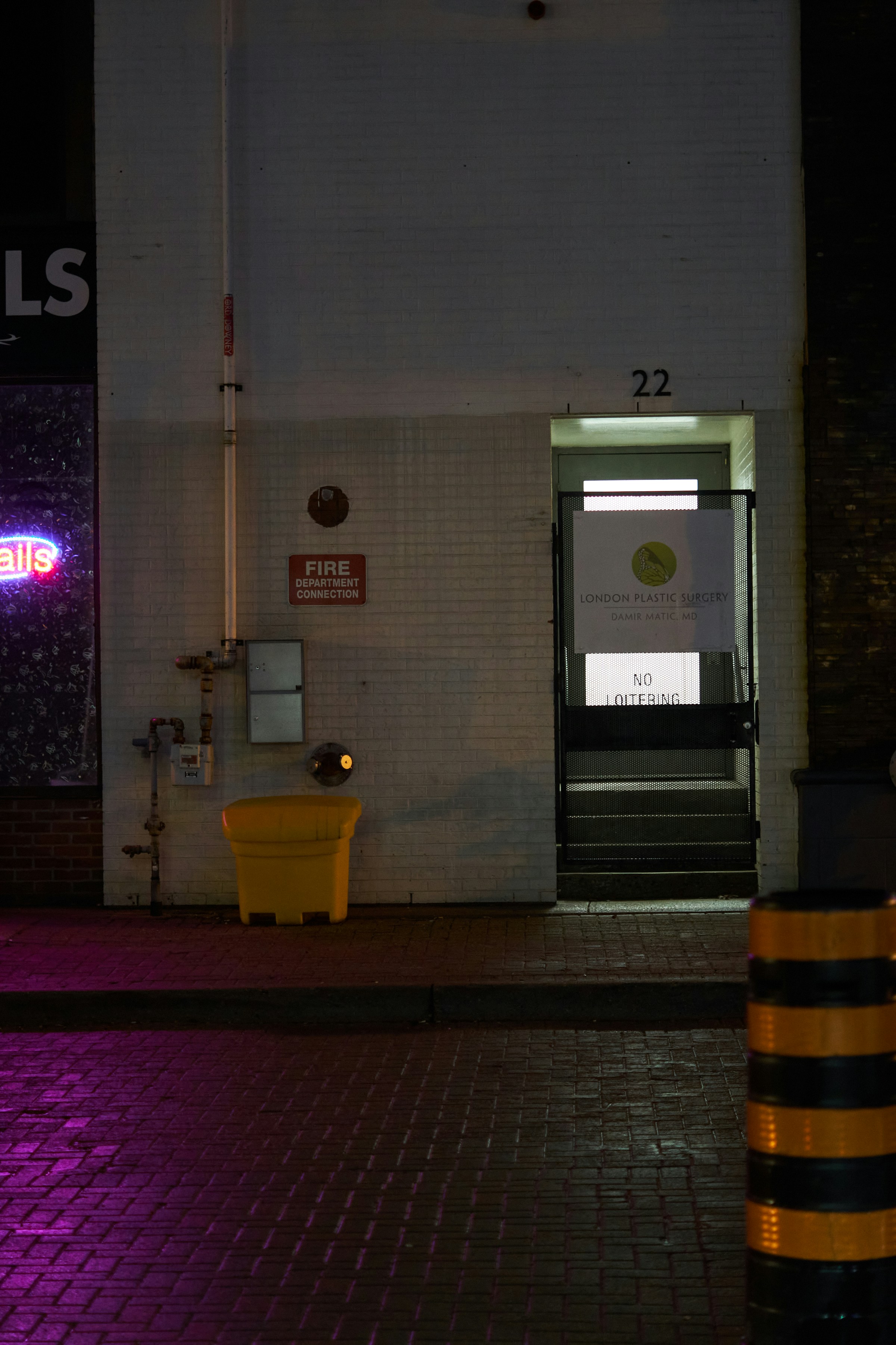 Building entrance at night with yellow barrier