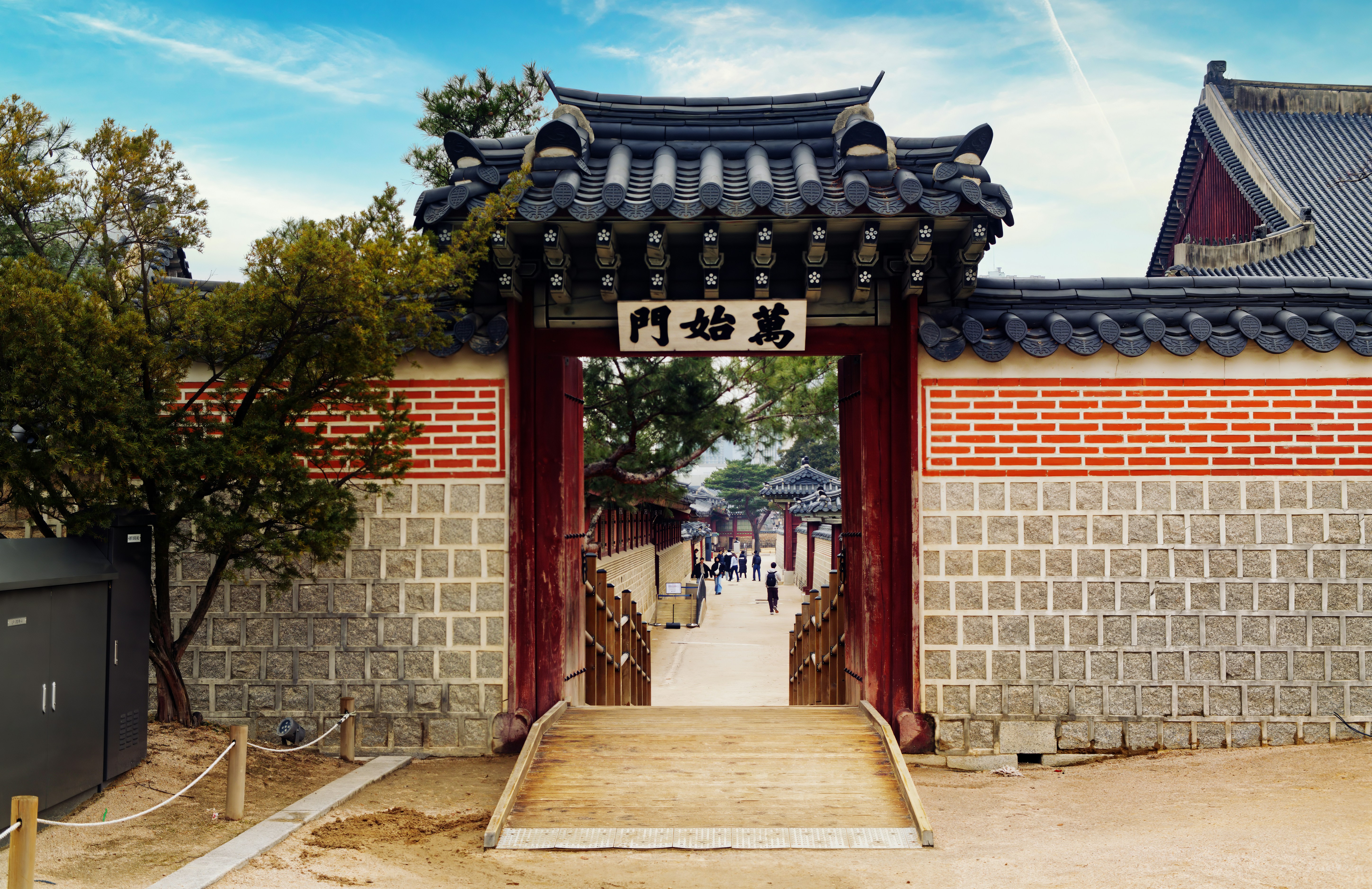 Traditional korean gate with stone walls and tiled roof