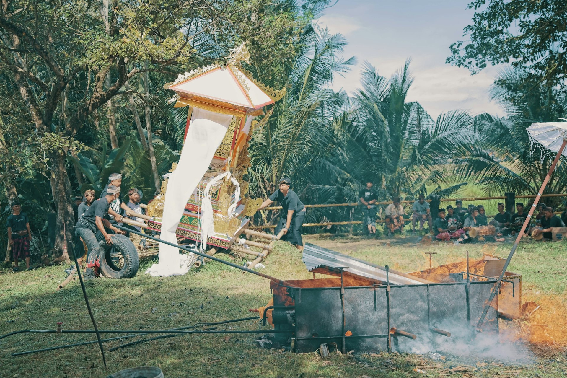 People preparing a large ornate structure outdoors