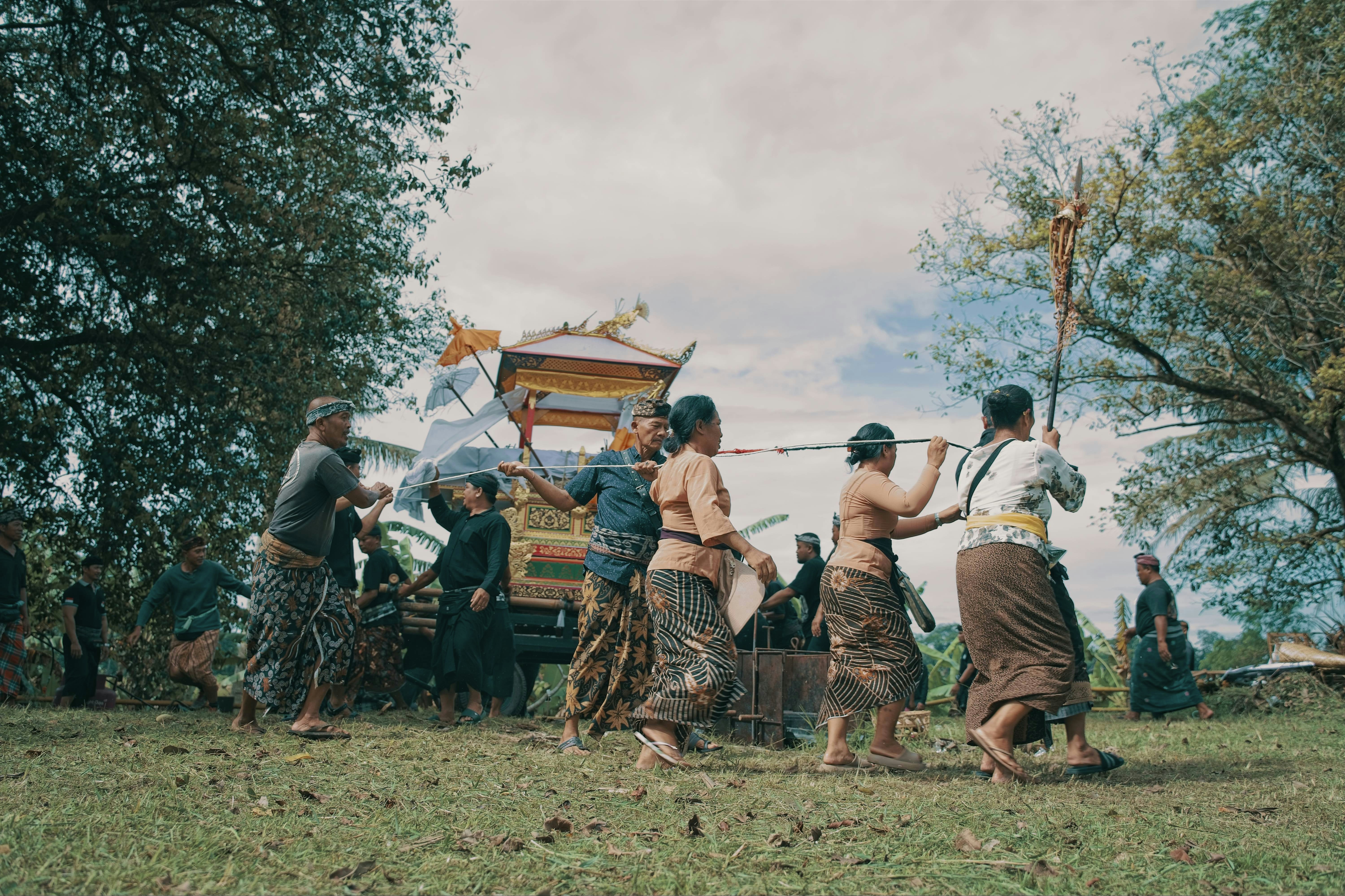 People carry a decorated carriage in a procession.