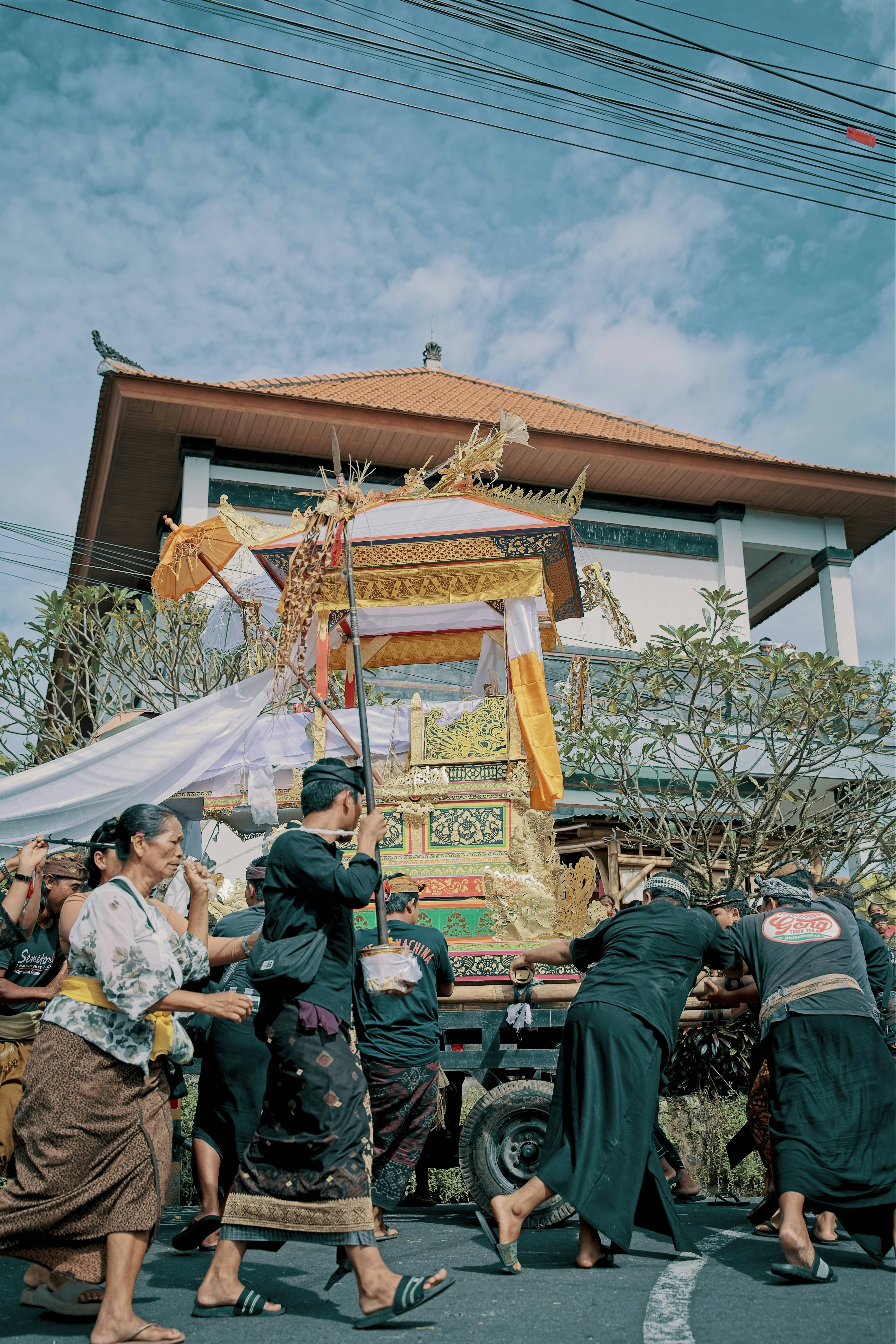People carry ornate coffin during a balinese procession.