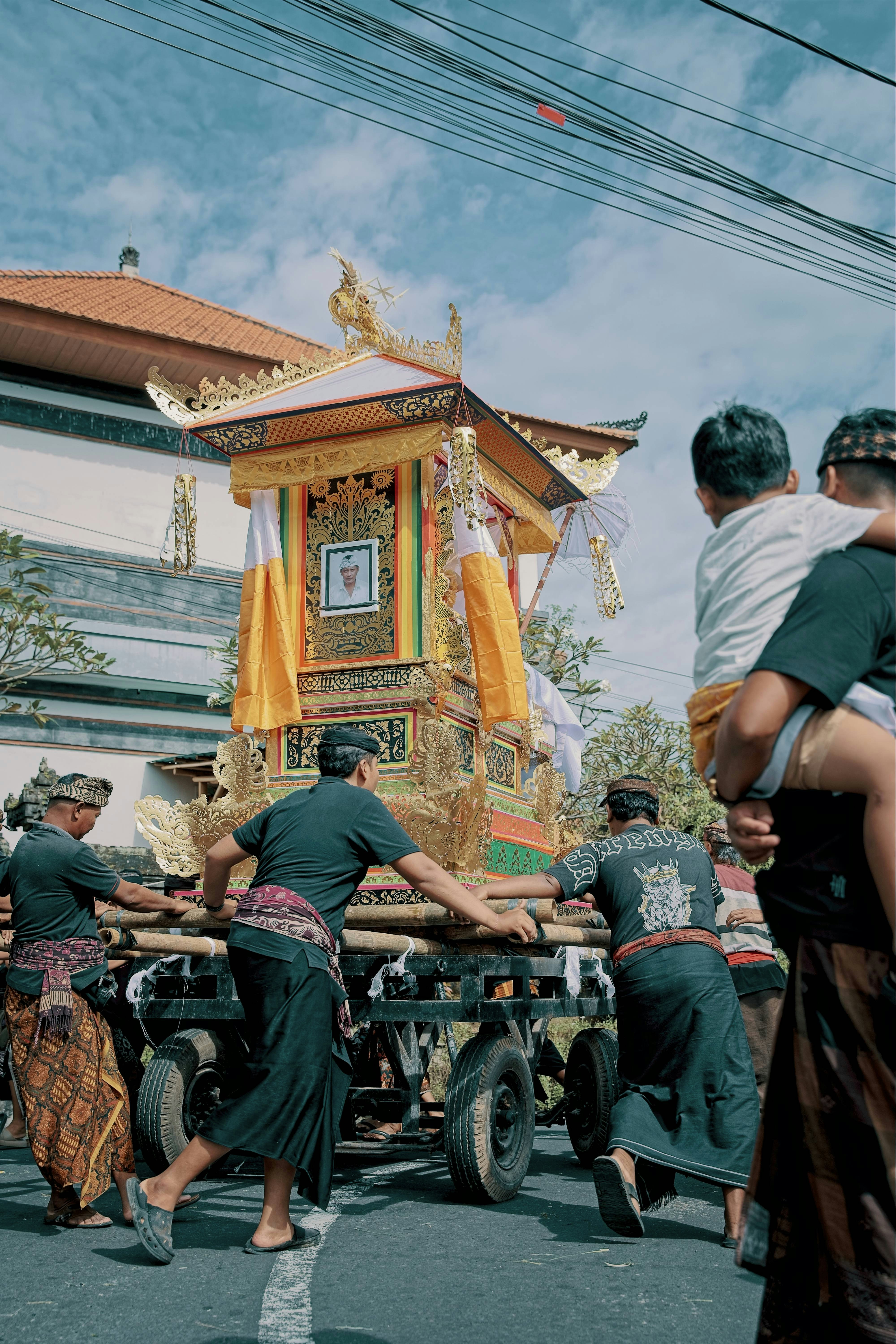 Men carry a decorated float in a procession