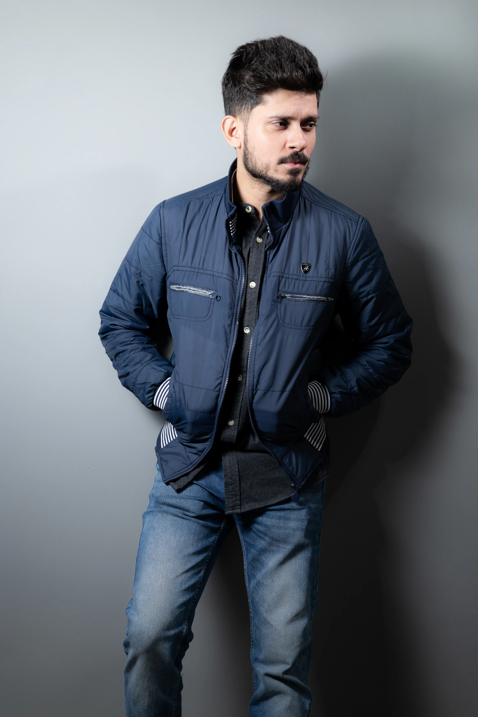 Man styled in a modern blue jacket and denim