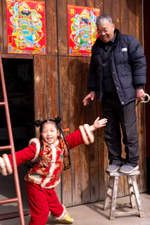 Grandfather and granddaughter in traditional outfits