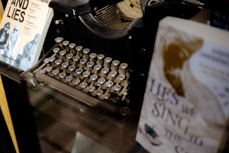 Antique typewriter with books — Contact J.P. Barelli
