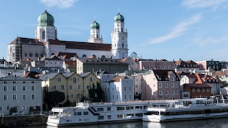Historic european city skyline with river and cruise ships.