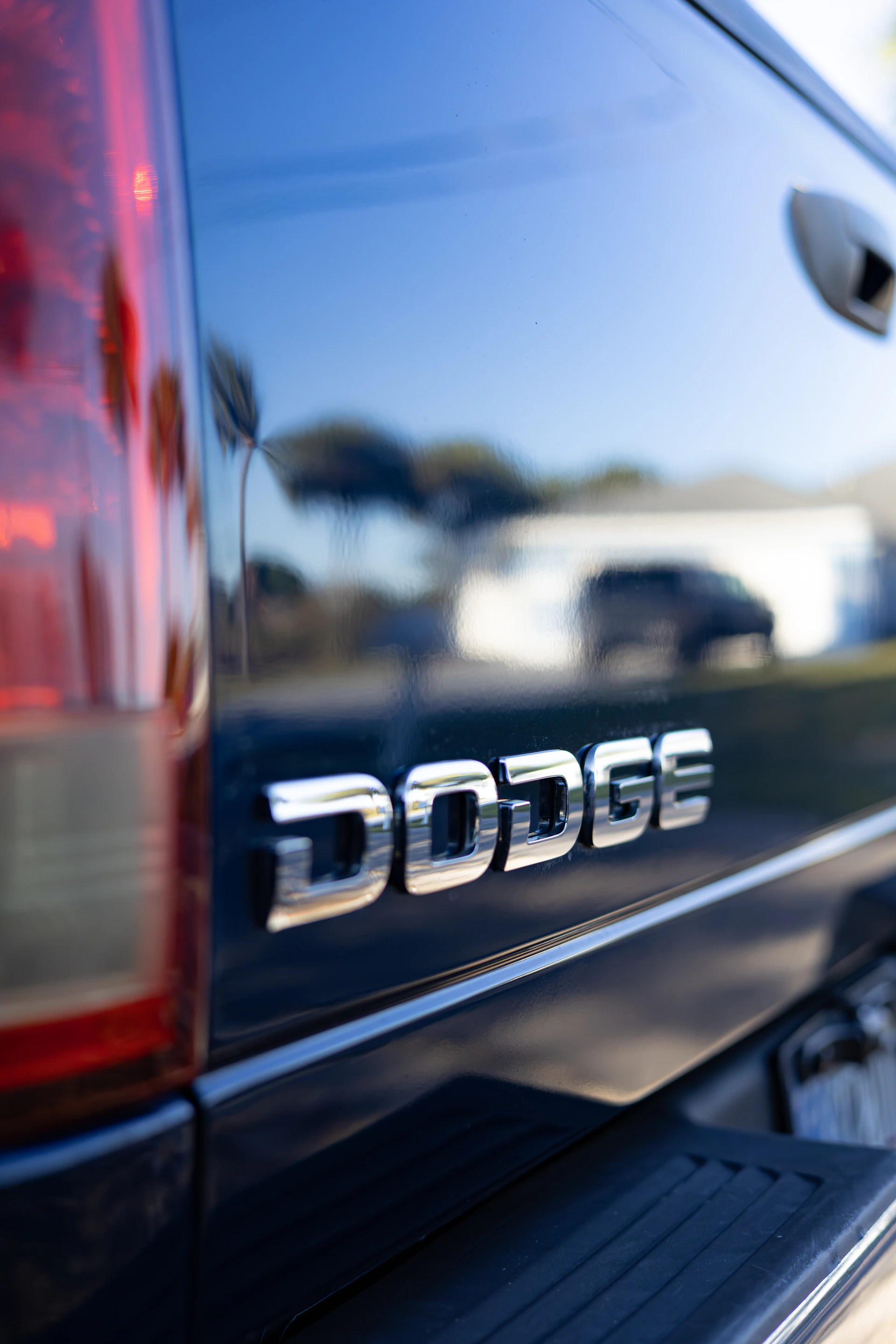 Close-up of the dodge emblem on a dark truck.