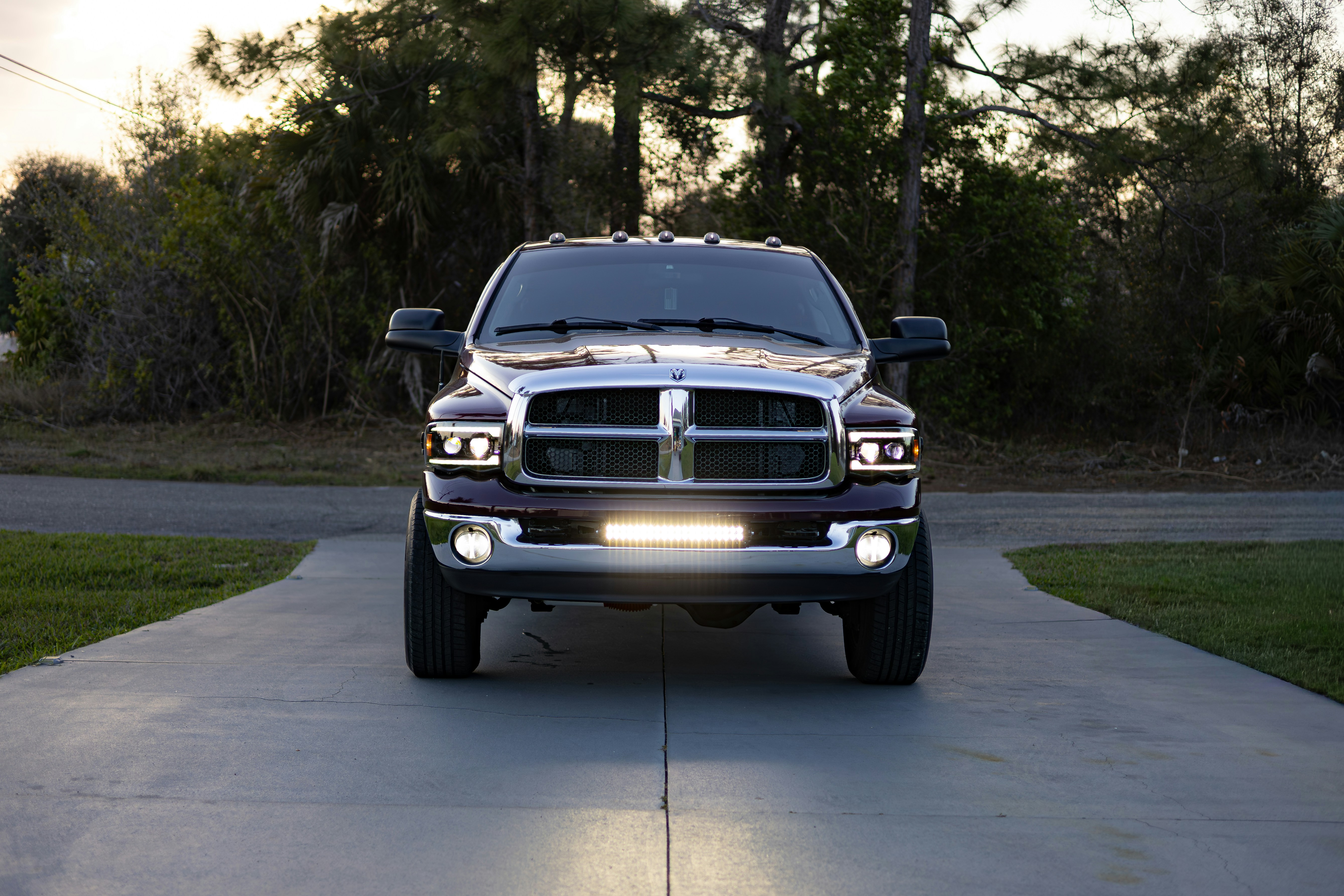 Front view of a dark pickup truck on driveway.