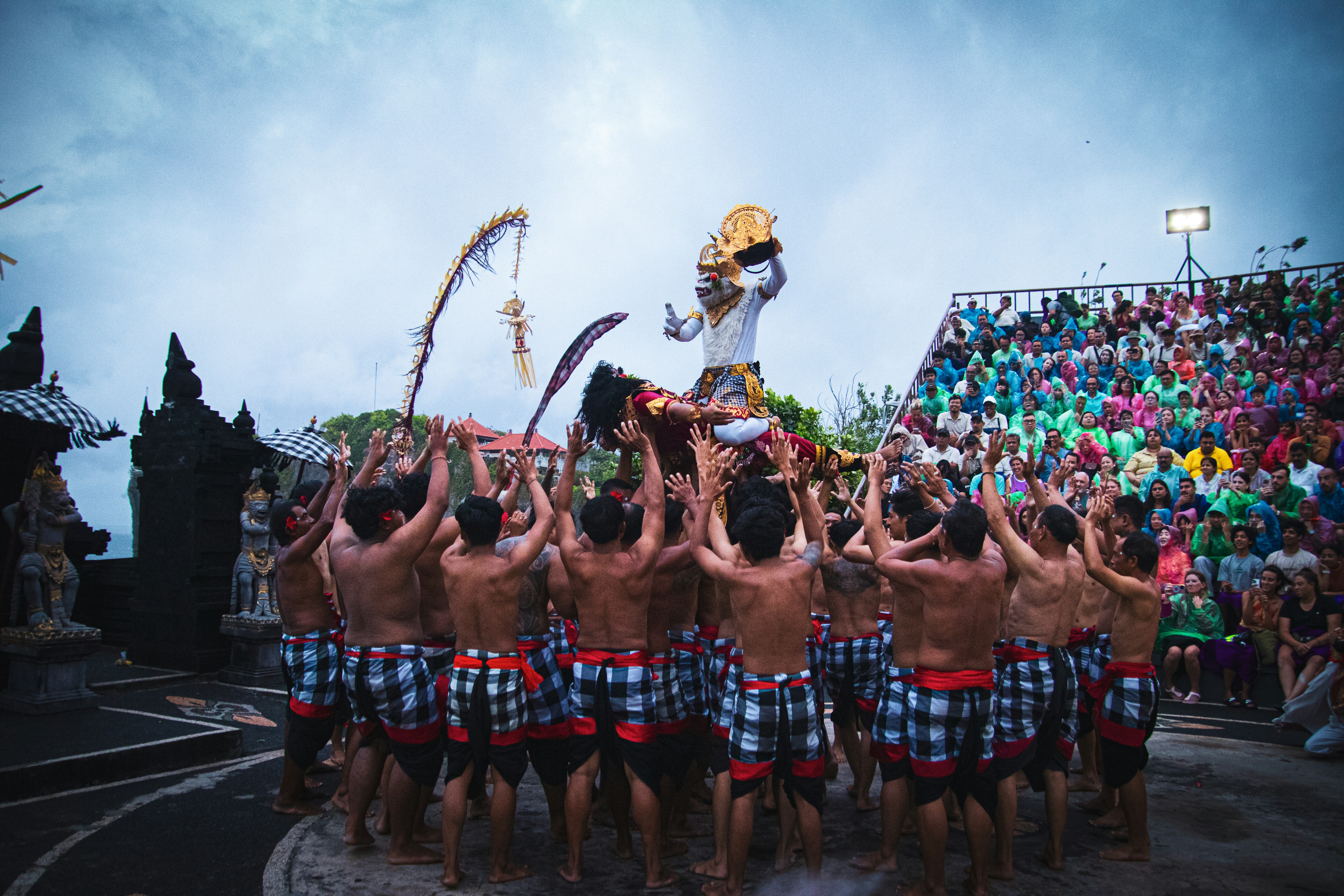 Dancers perform a traditional ritual with audience watching
