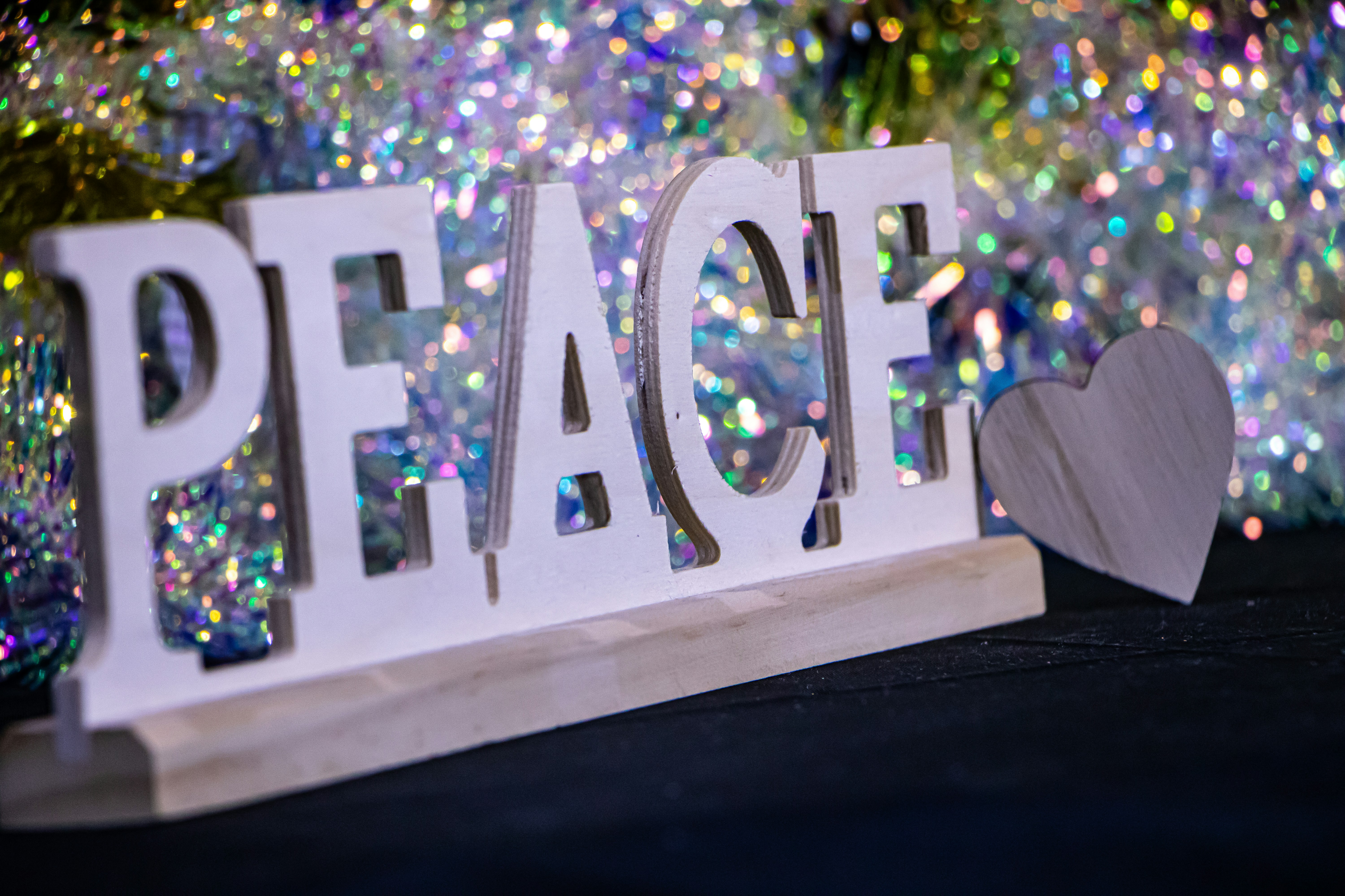 Wooden letters spell peace with a heart decoration