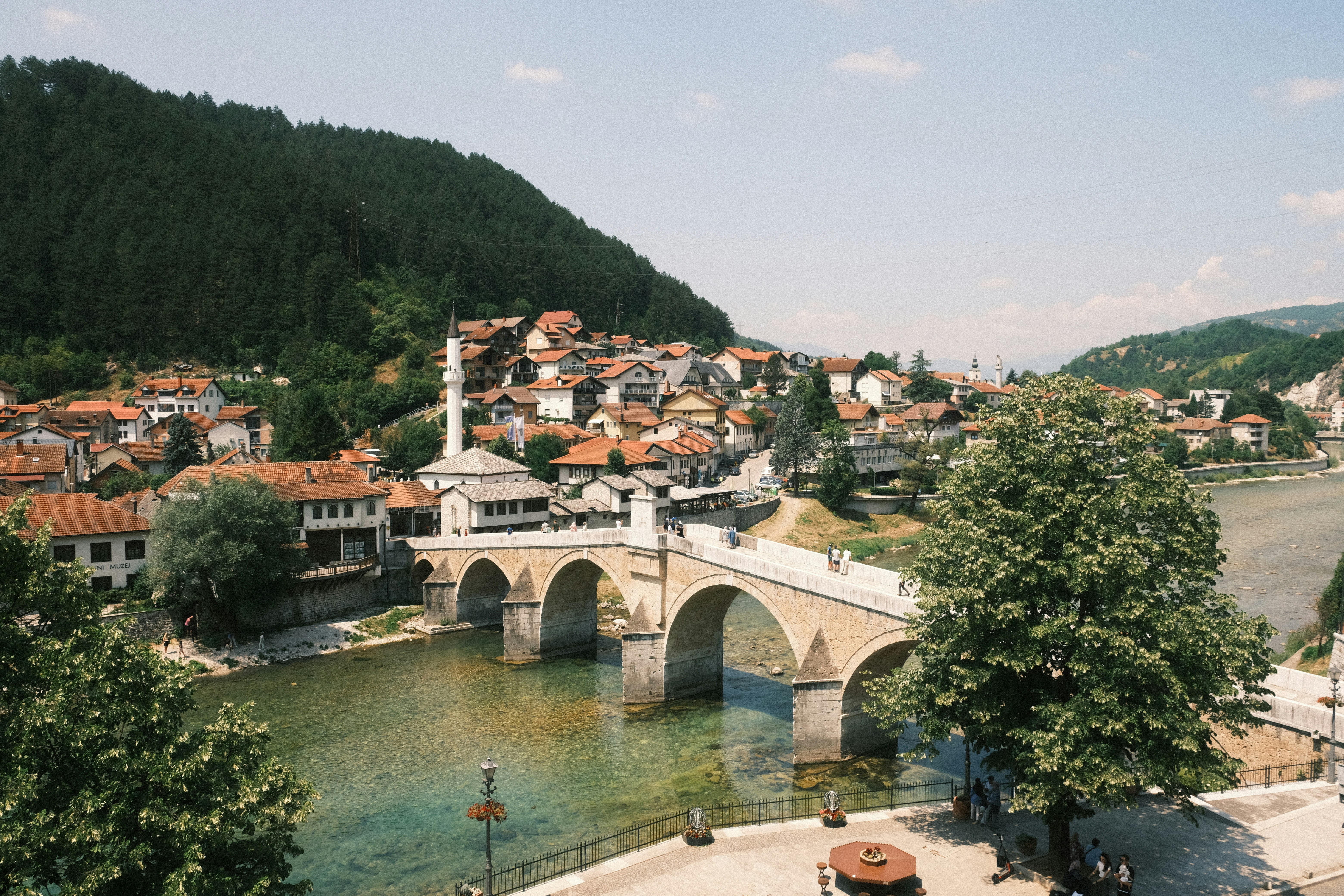 Stone arched bridge over a river in a town.