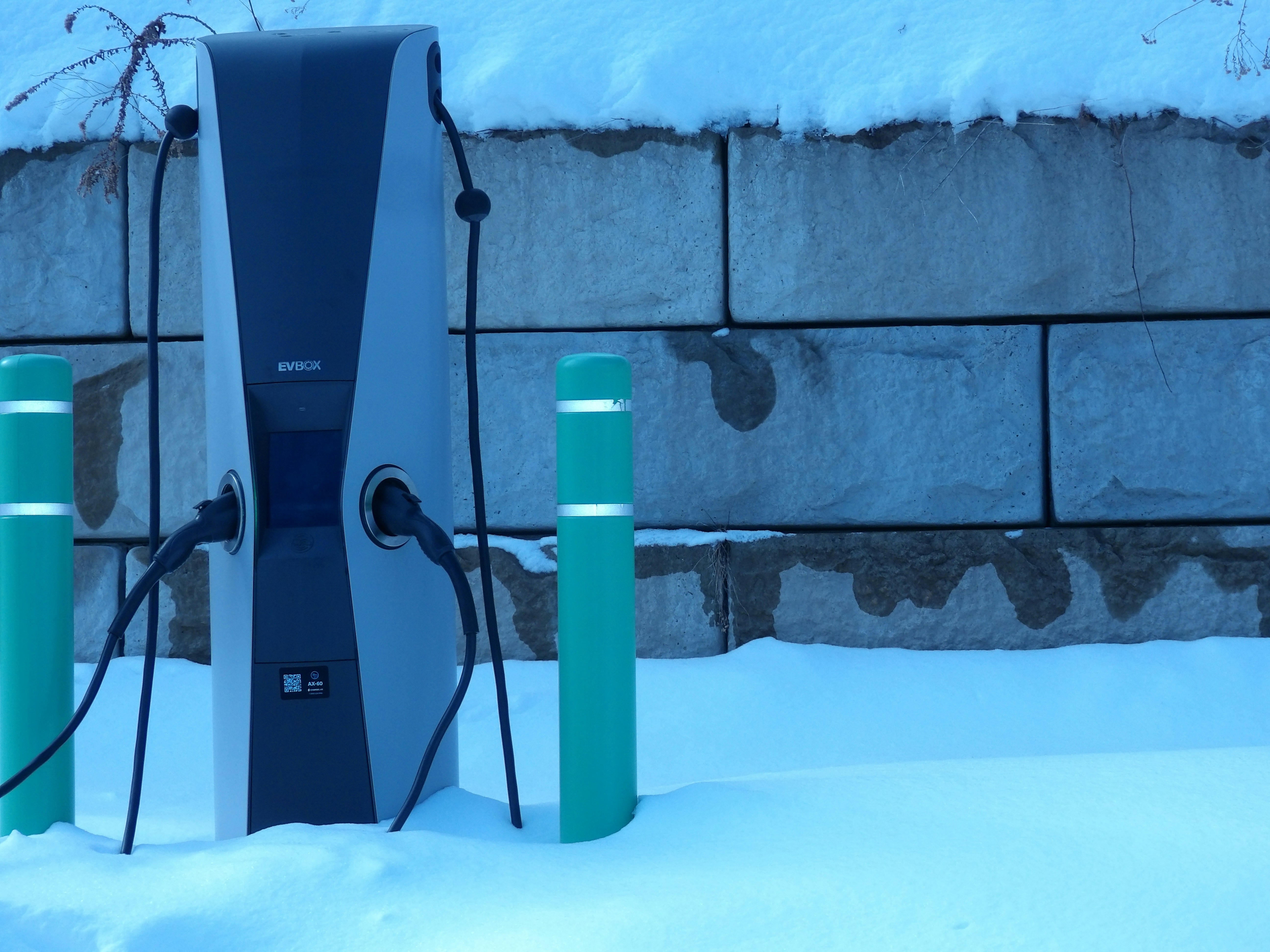 Electric car charging station covered in snow
