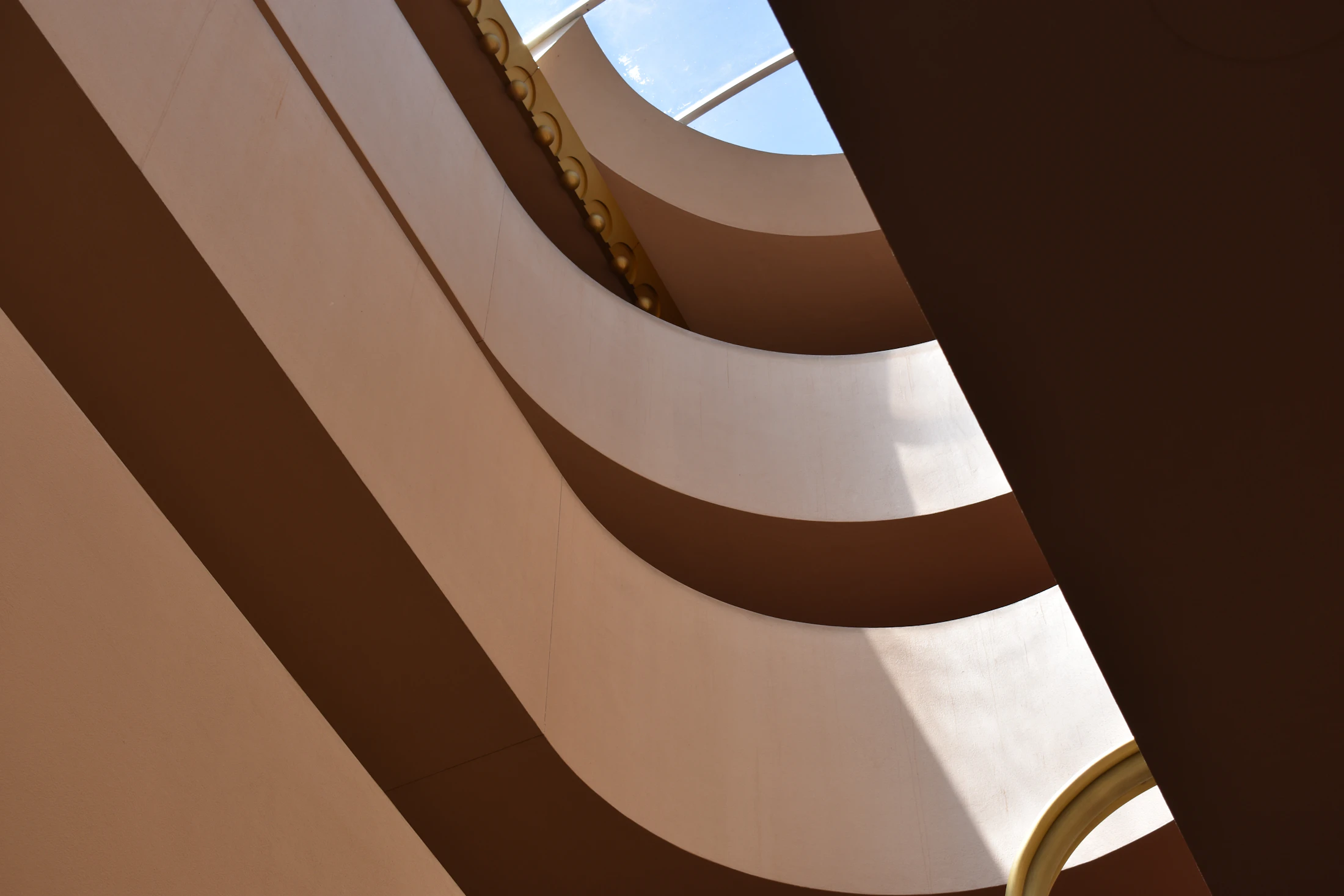 Curving earthen architecture against the sky