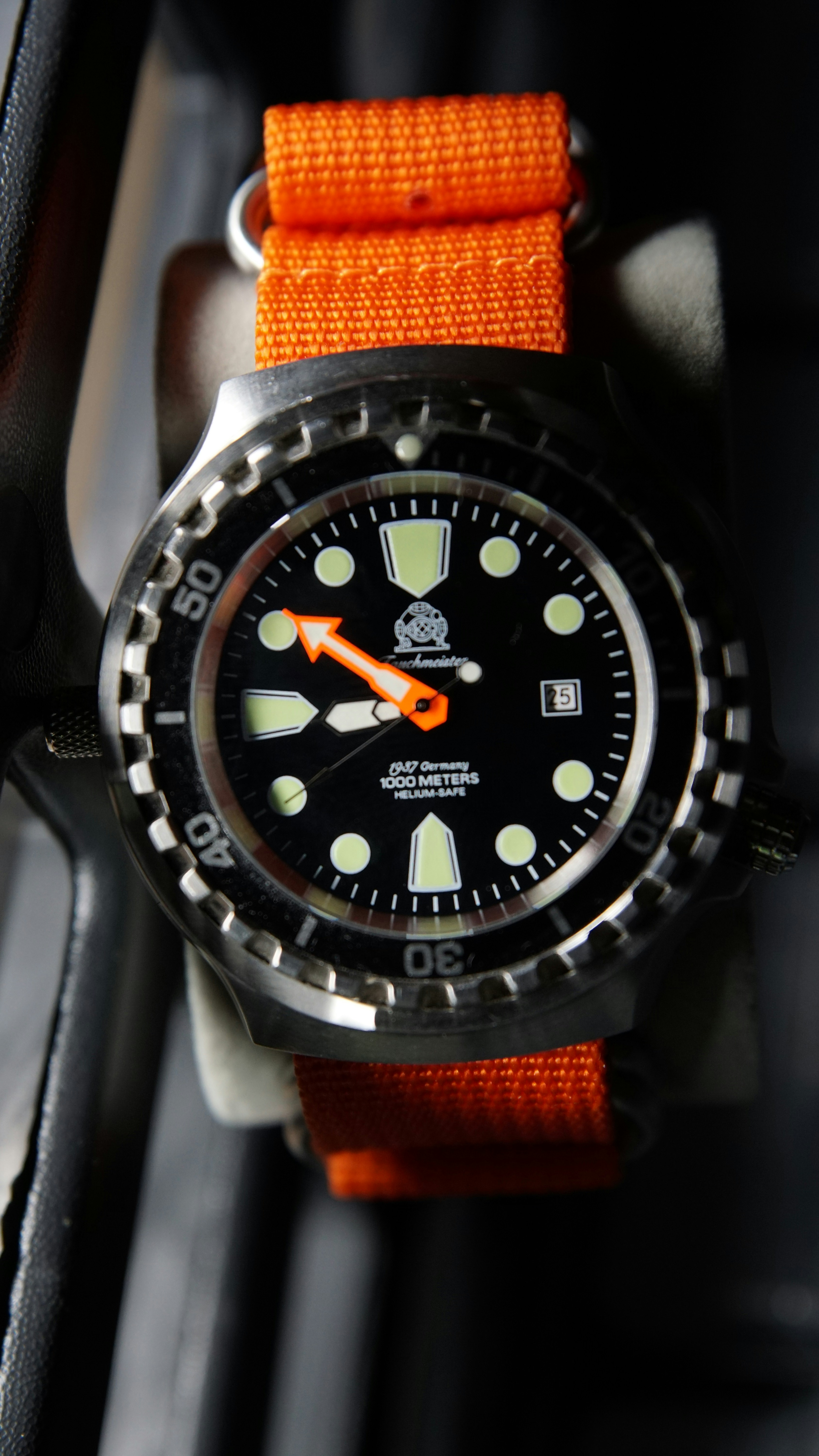A diver's watch with an orange strap