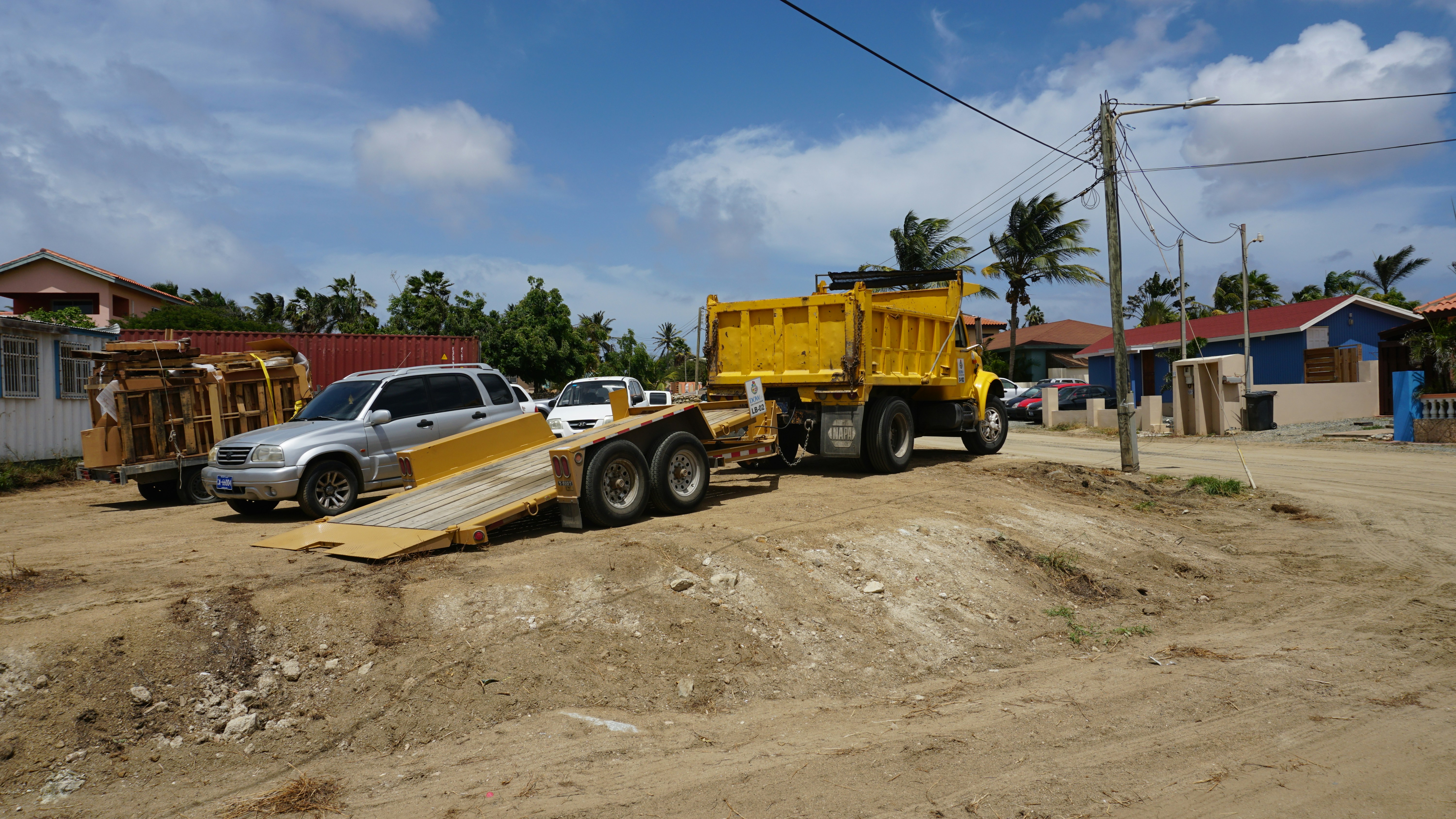 Yellow dump truck towing a trailer