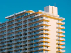 Modern hotel building with many balconies against blue sky