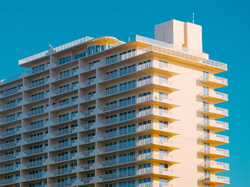 Modern hotel building with many balconies against blue sky