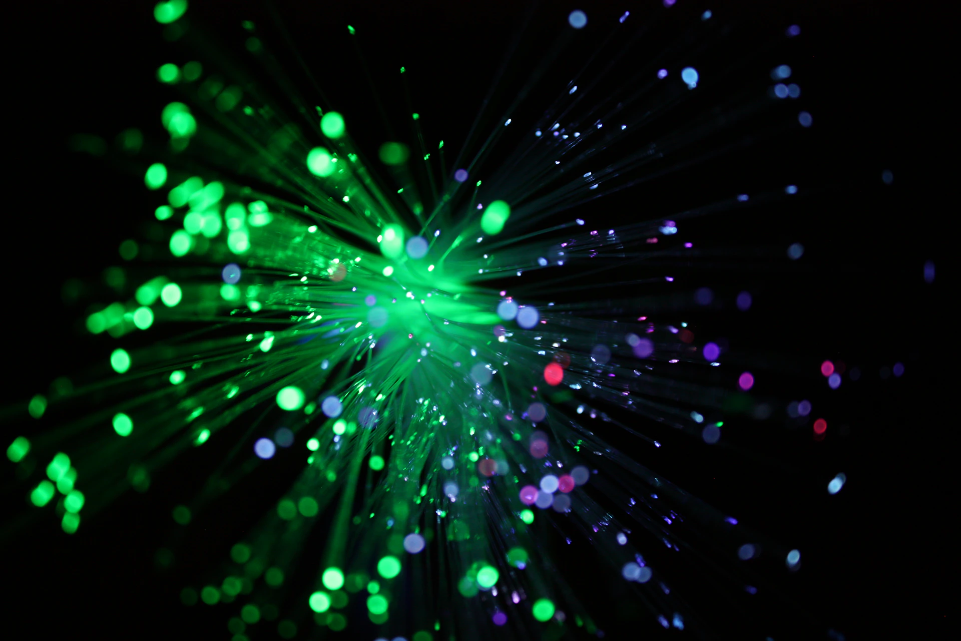 Abstract explosion of green and purple lights