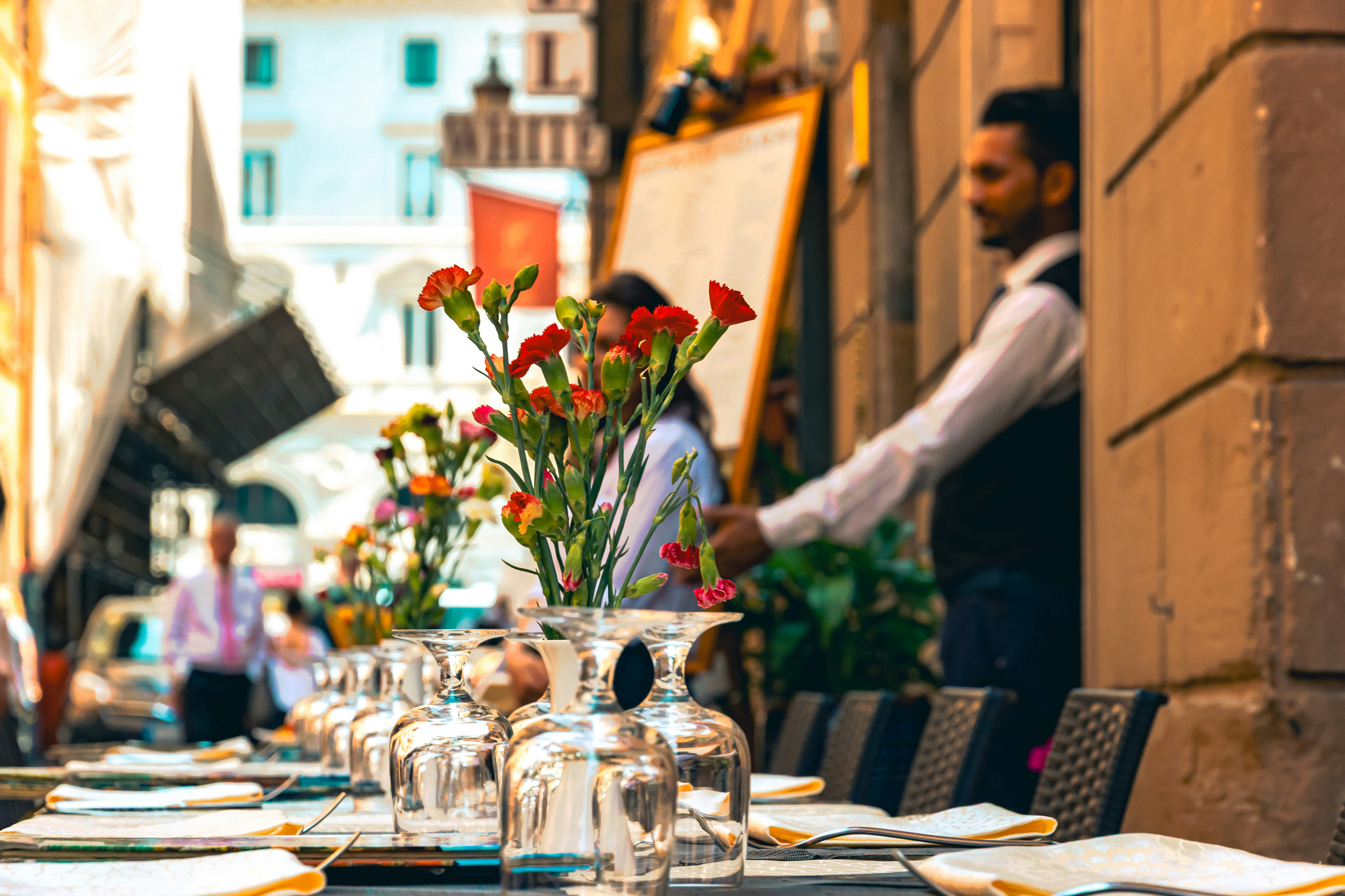 Waiter serving tables outside a european restaurant