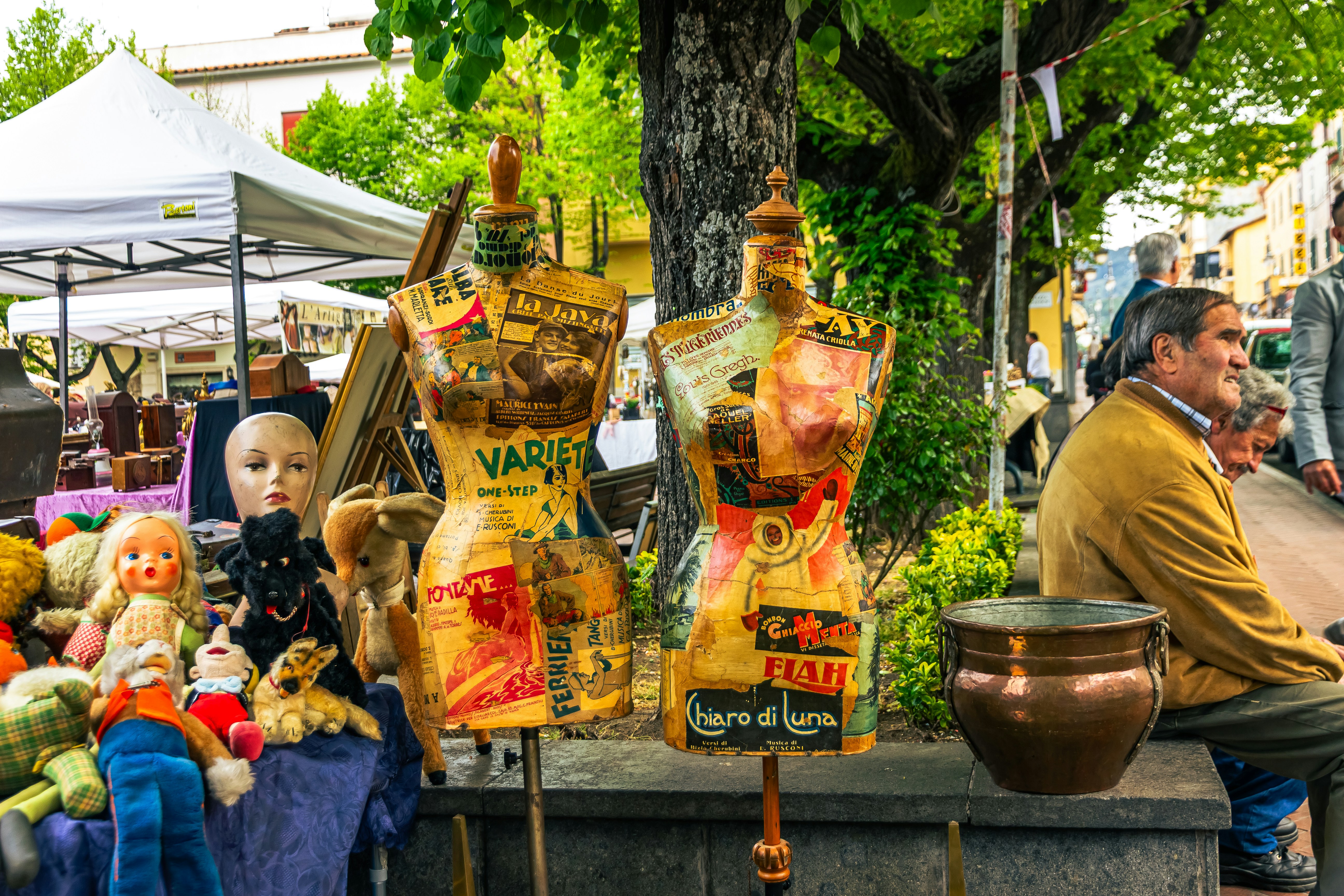 Vintage mannequins and dolls at an outdoor market.