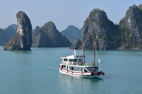 Halong Bay cruise sailing between dramatic karst pillars