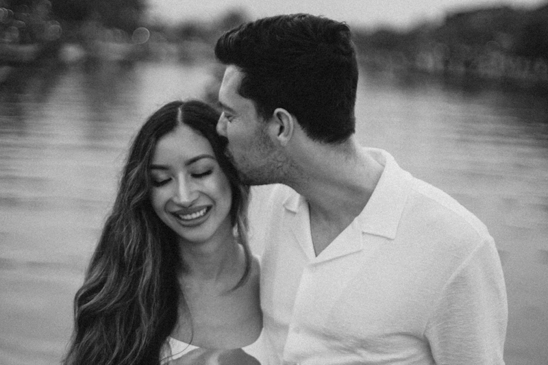 Herpes-aware couple embracing by the water