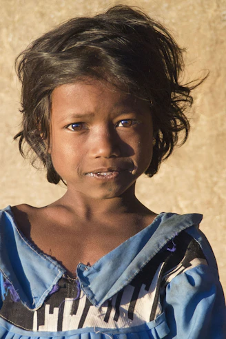 Young girl with dark hair and blue dress