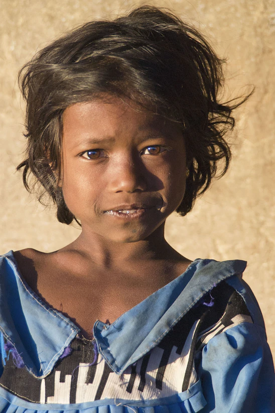 Young girl with dark hair and blue dress