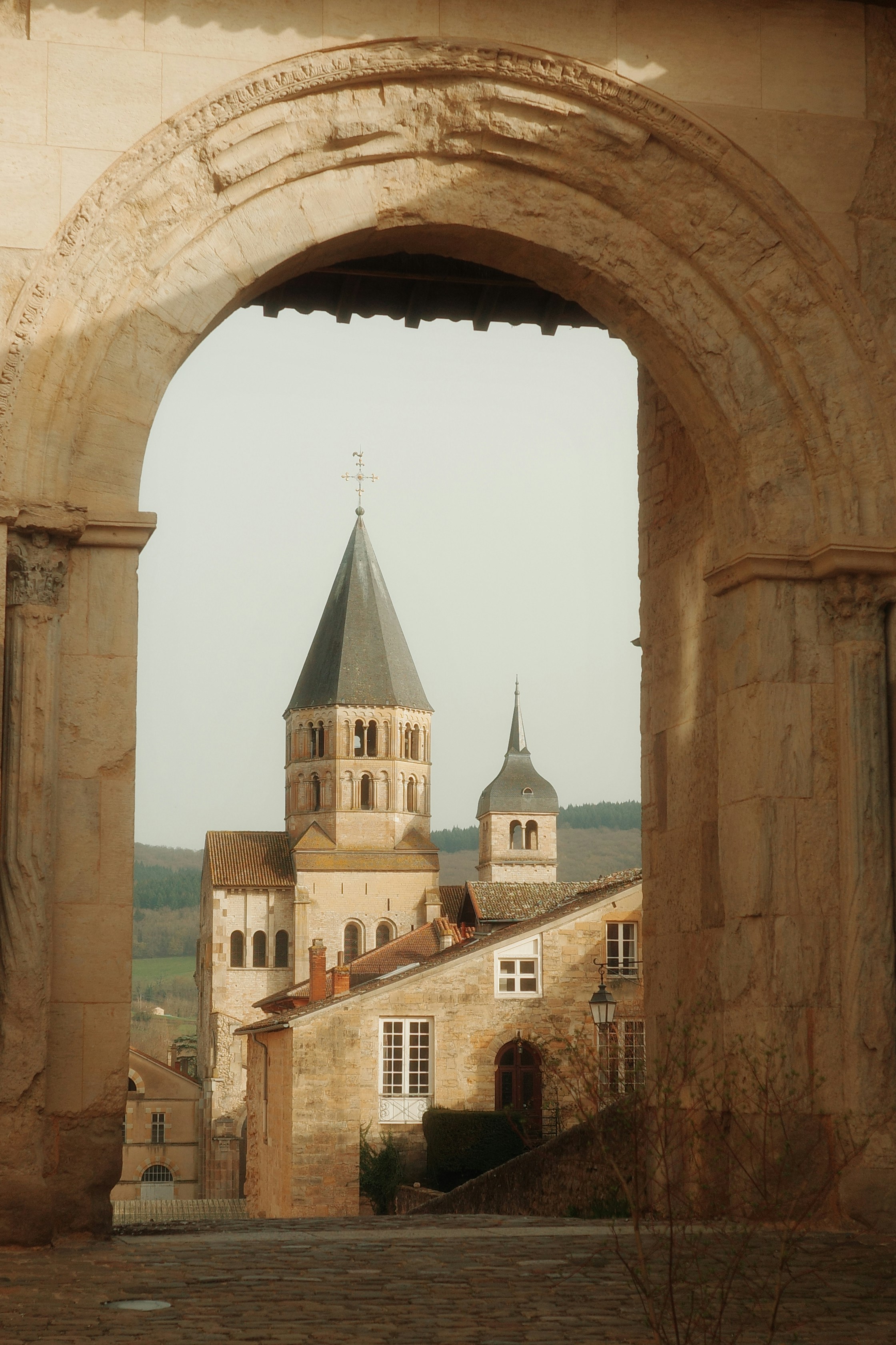 View through archway of historic church and buildings