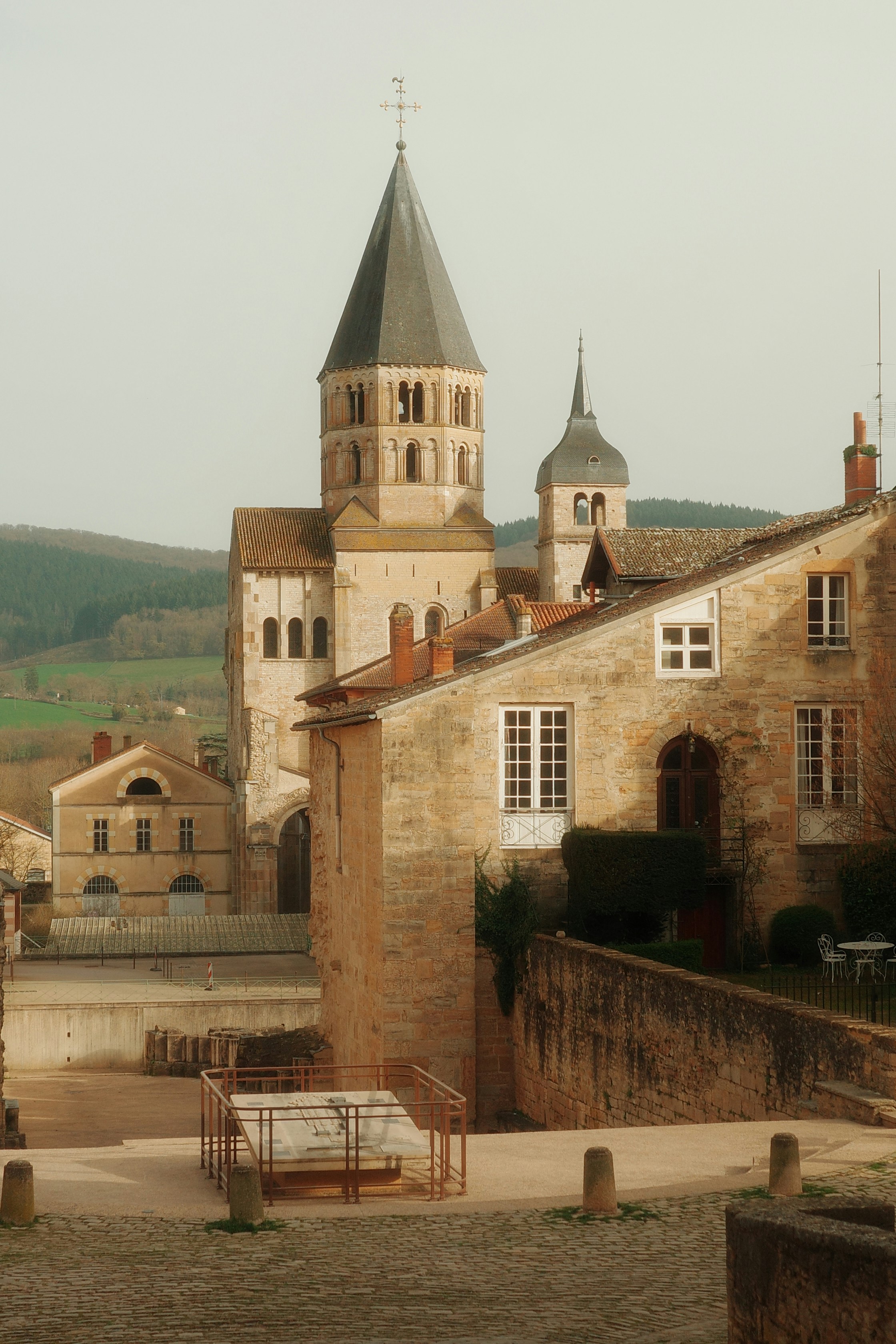 Historic stone buildings with a tall church spire.
