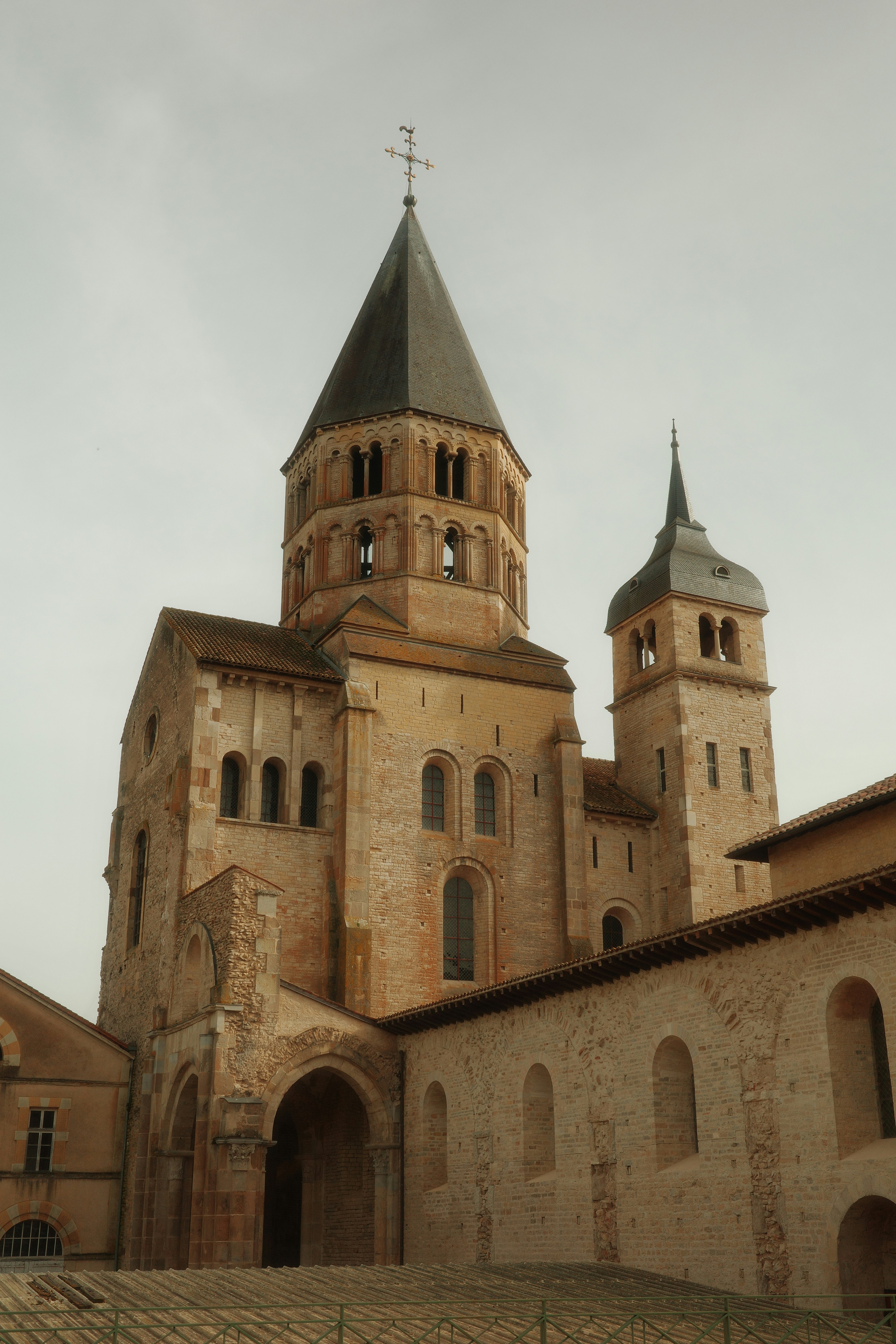 Ancient stone church with tall spire and bell tower