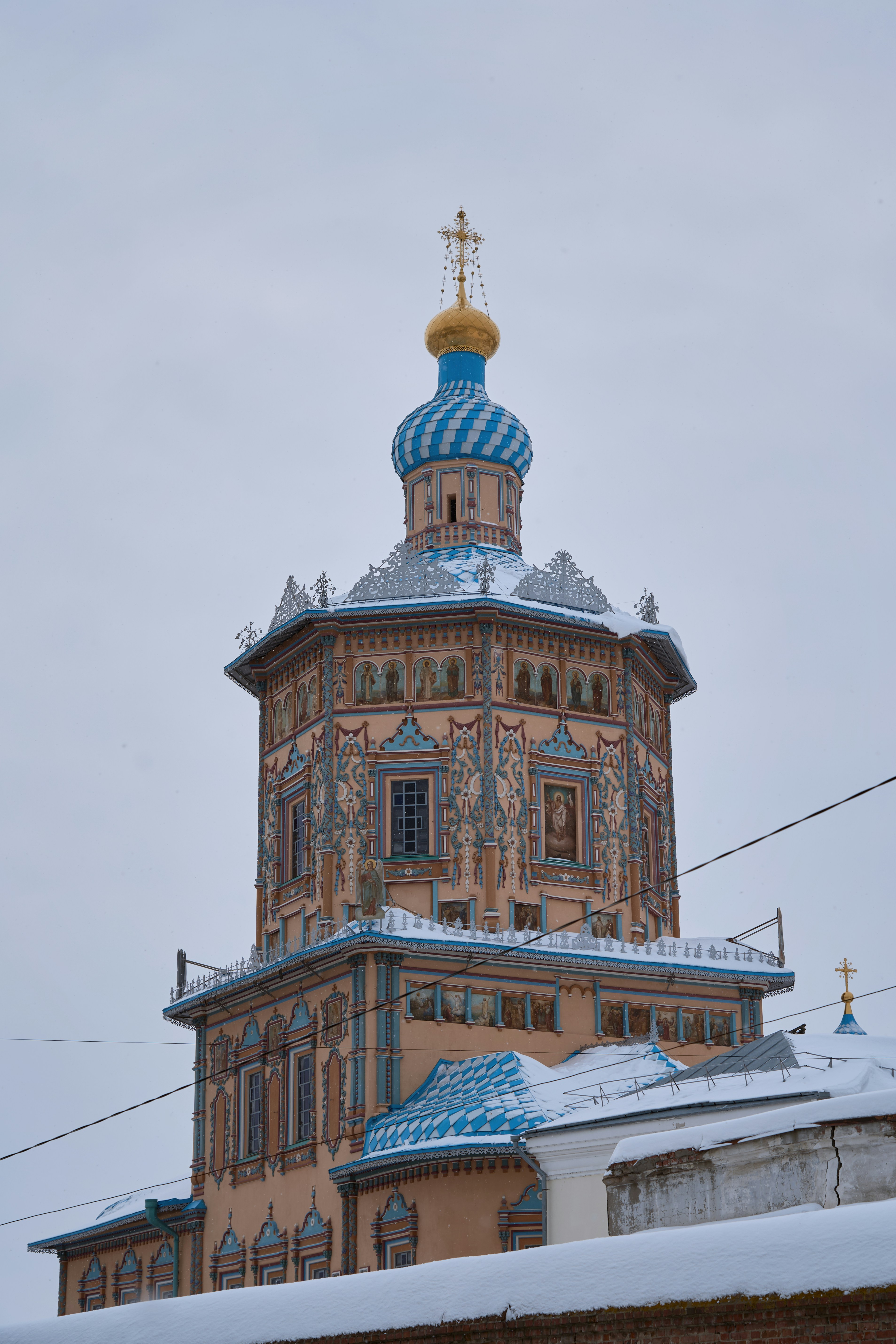 Ornate building with blue domes under a cloudy sky