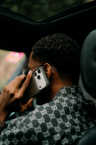 Man talking on a smartphone inside a car