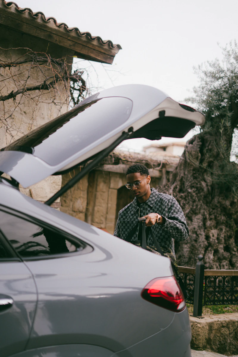 Driver loading luggage into the car