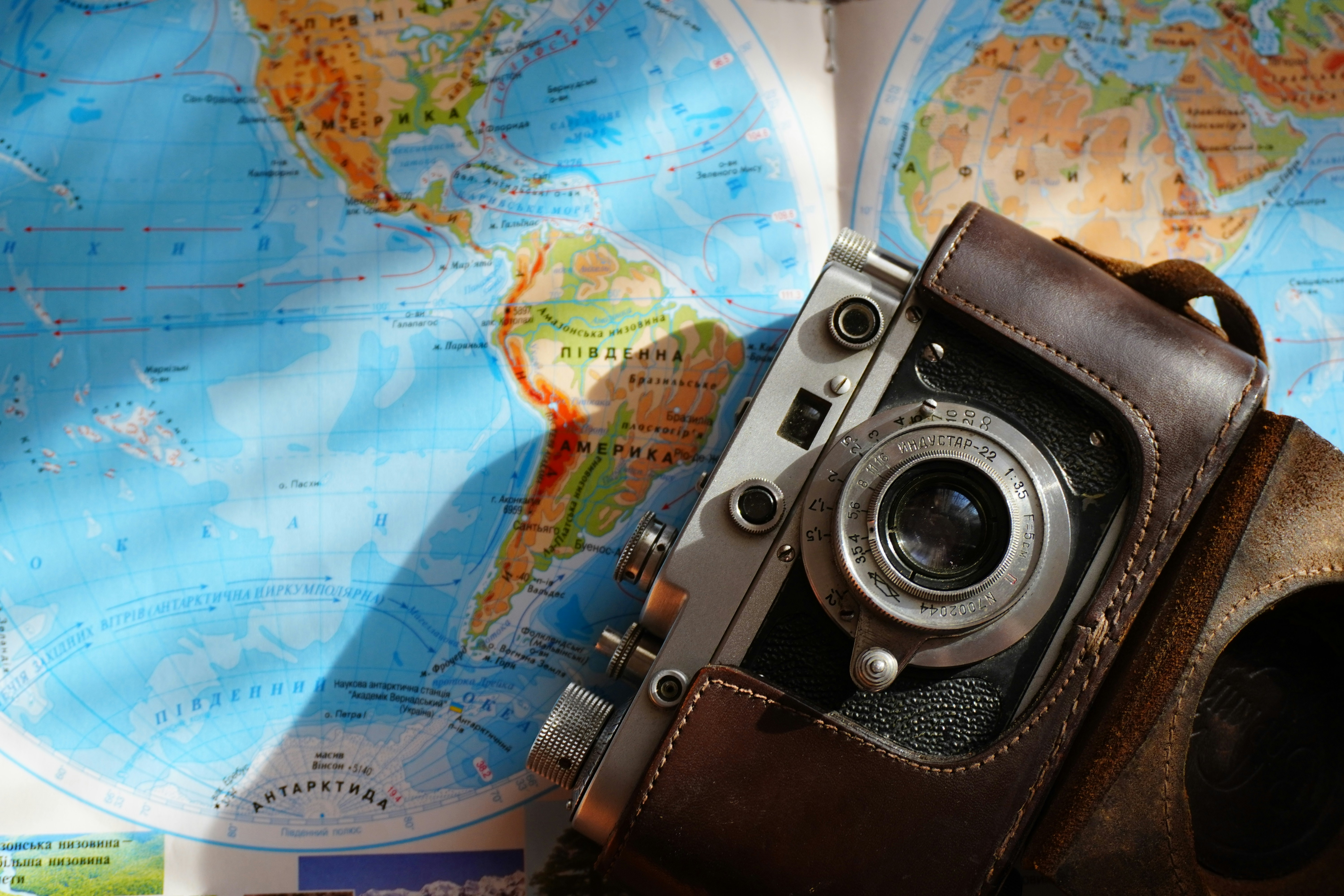 Vintage camera rests on a world map