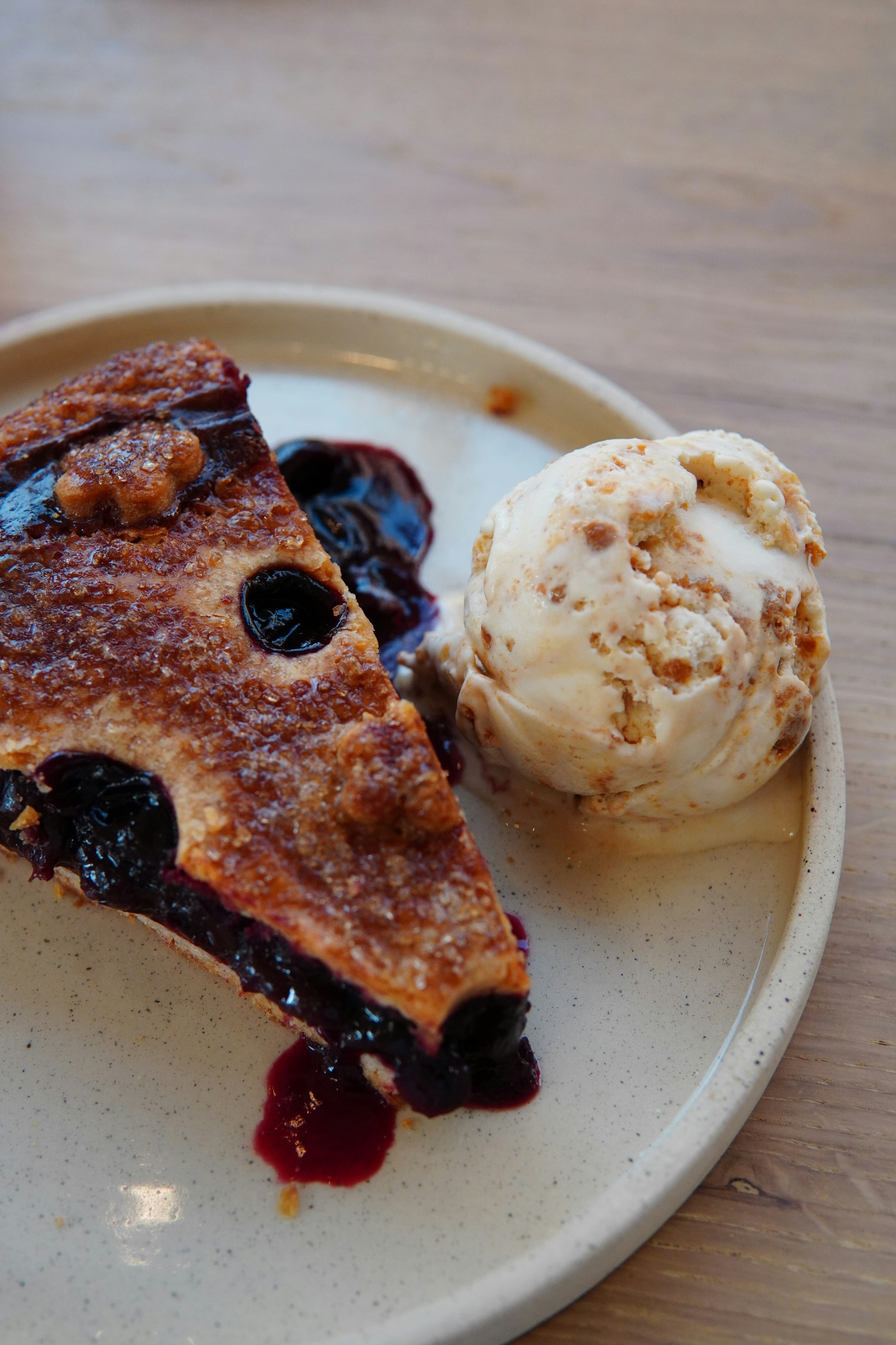 Slice of blueberry pie with ice cream