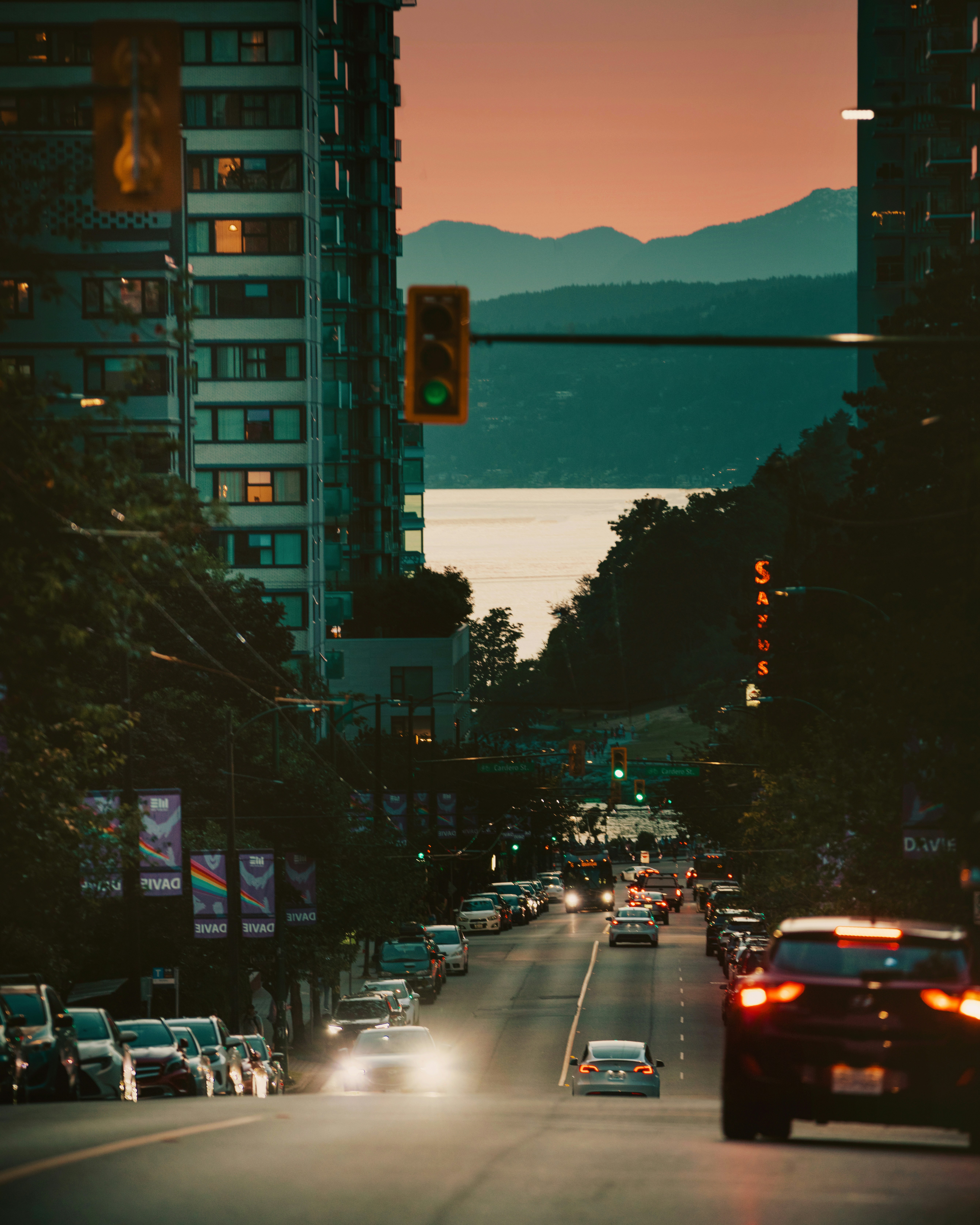 City street with cars and mountains at sunset