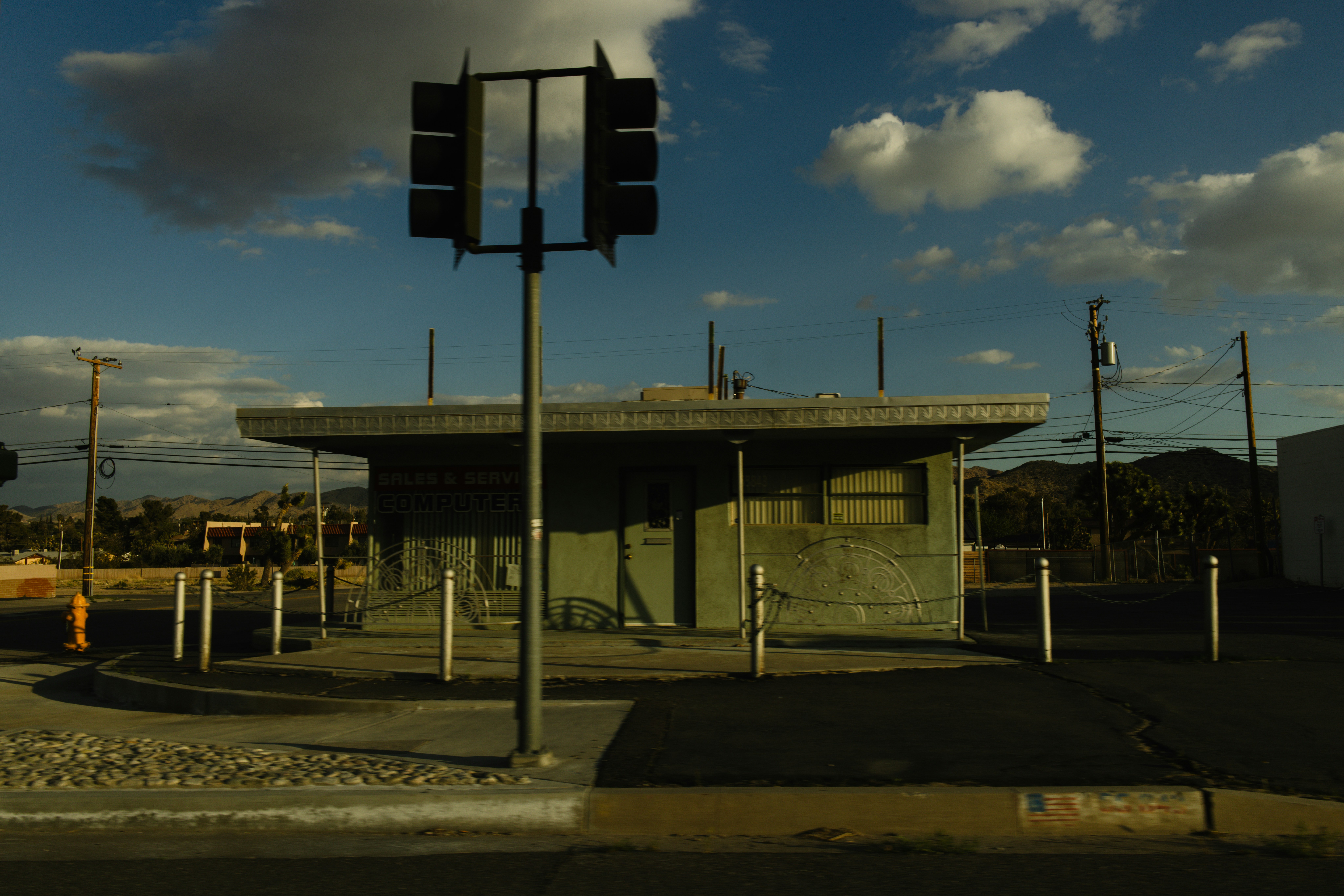 Abandoned building with traffic signal under cloudy sky