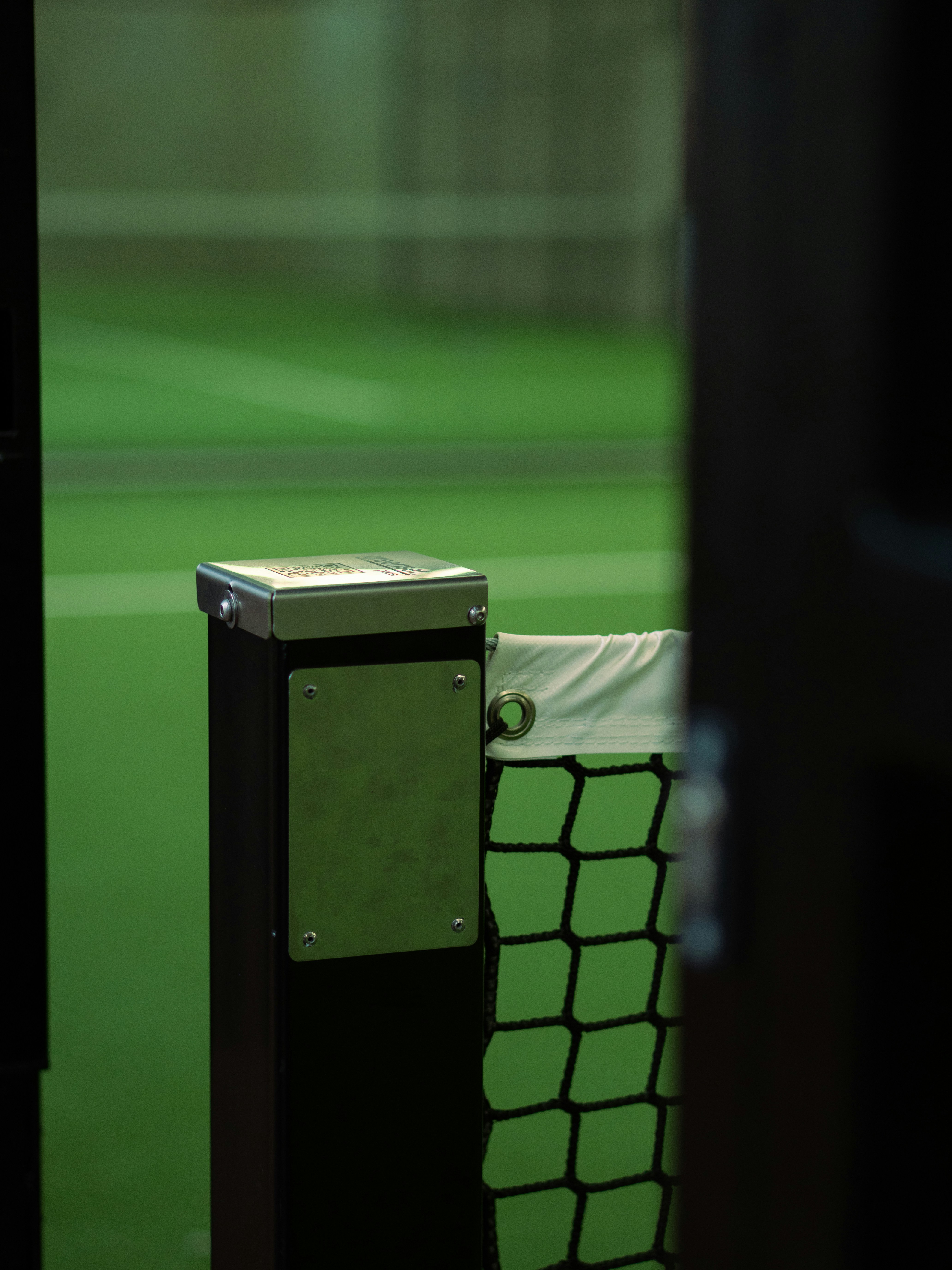 Sports court net post with green background